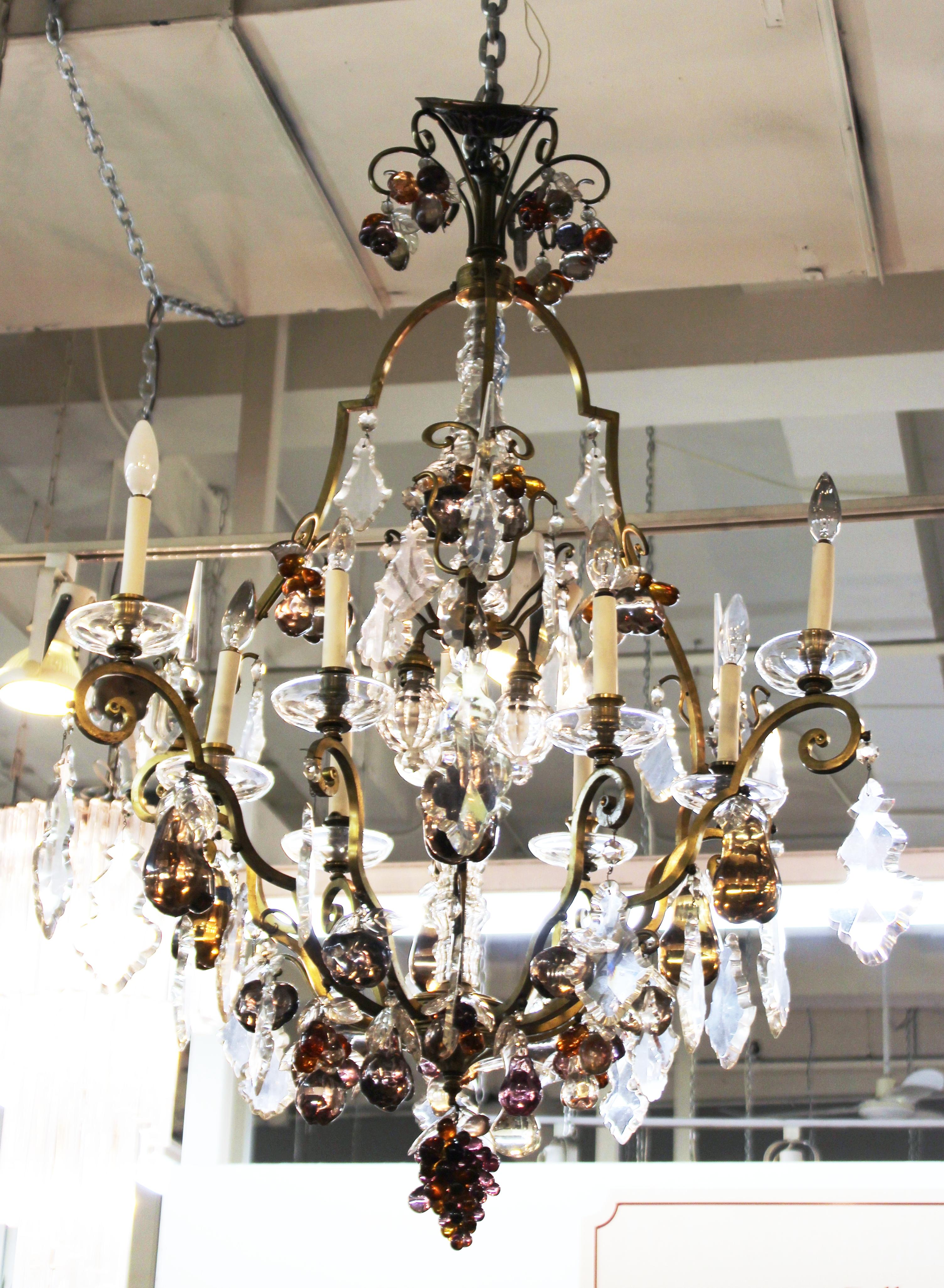 American Hollywood Regency monumental chandelier with crystal elements and multicolored crystal fruit elements on an elaborate brass frame. The piece is in good vintage condition and was made in the mid-20th century.