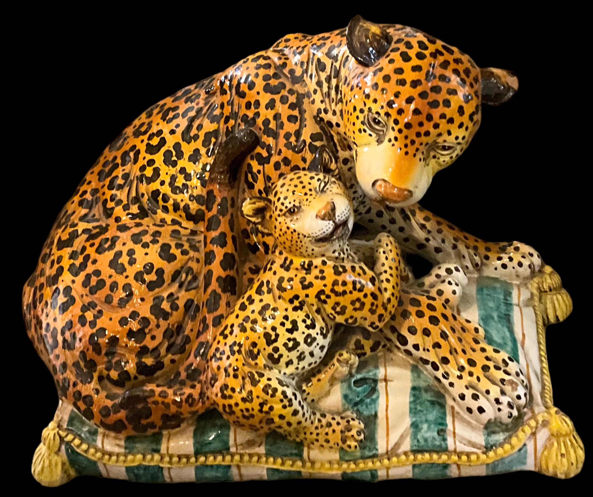 This is a rare piece! It is a Hollywood Regency era terracotta mother leopard and cub reclining on a striped pillow, it is attributed to Meiselman Imports and was a limited production piece. It is extremely heavy, so white glove shipping only.

My