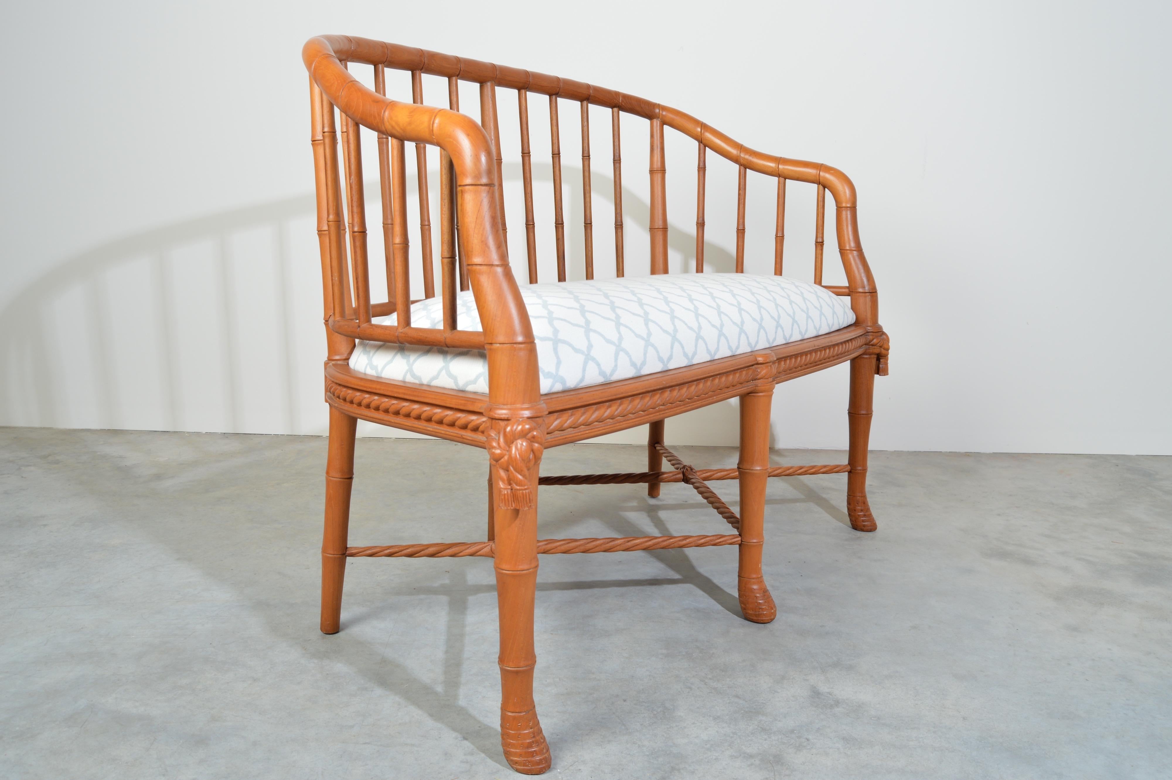 Carved teak barrel back settee. Faux bamboo down to the carved rootball feet with ornate rope & tassel details similar to Napoleon chairs. 
Newly upholstered in designer trellis fabric. 
(Matching sofa and pair of chairs also available on our