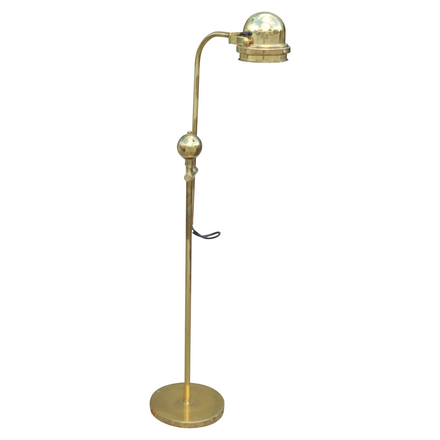 Gorgeous Hollywood Regency style articulating solid brass floor lamp with a nautical design.