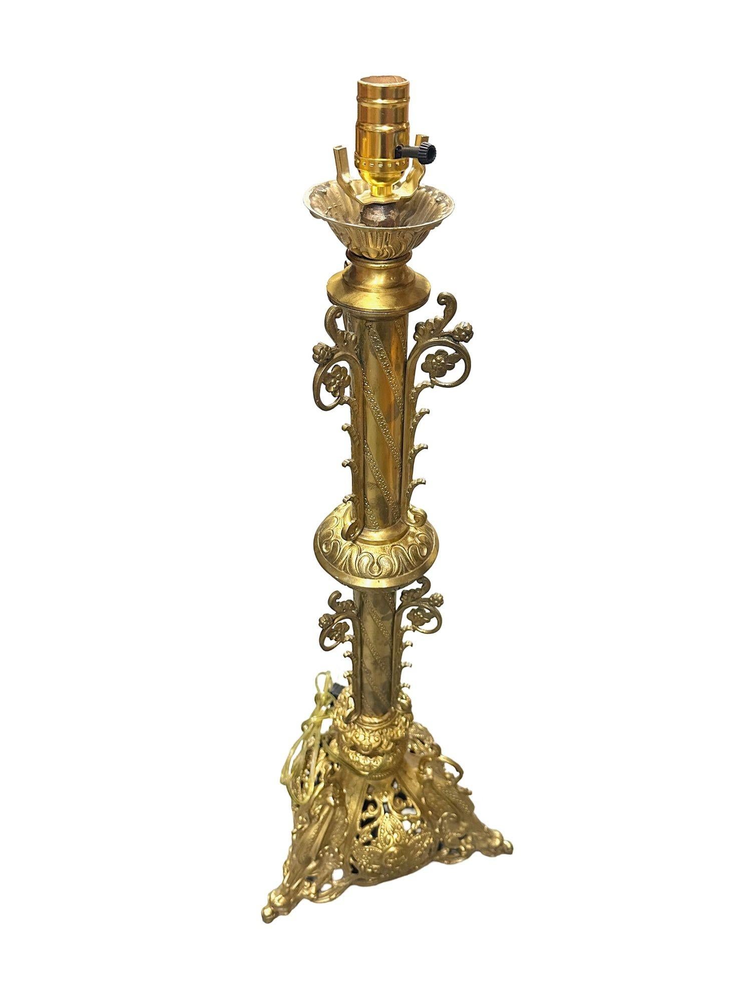 This original Hollywood Regency Neo-Gothic-inspired table lamp is made from solid brass and features dragon figures adorning each corner, while prominent Celtic crosses with traditional knot work patterns highlight its heritage. The lamp has spiral