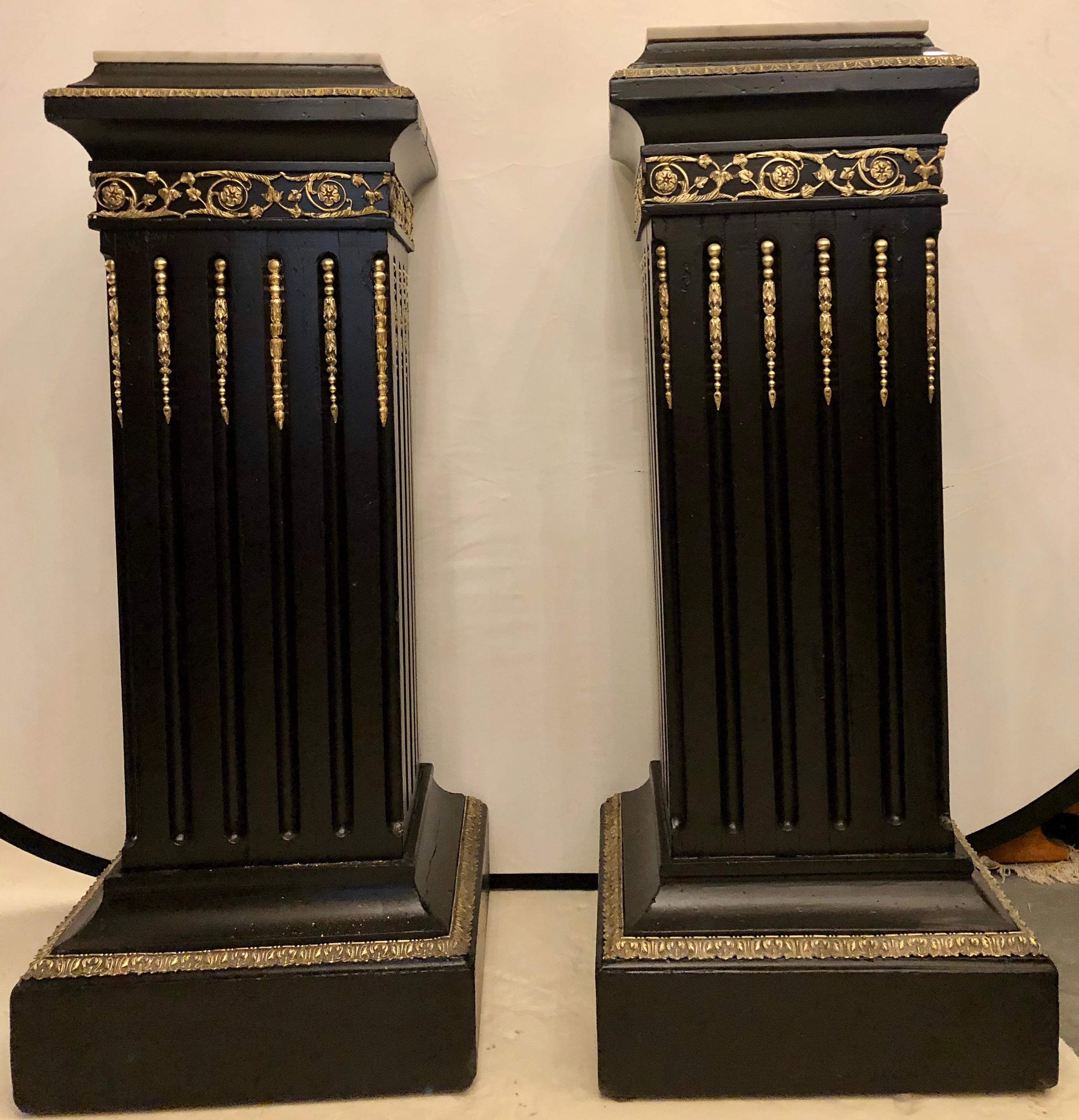 French Hollywood Regency Neoclassical Ebony Pedestals, Bronze Mounted Marble Tops, Pair For Sale