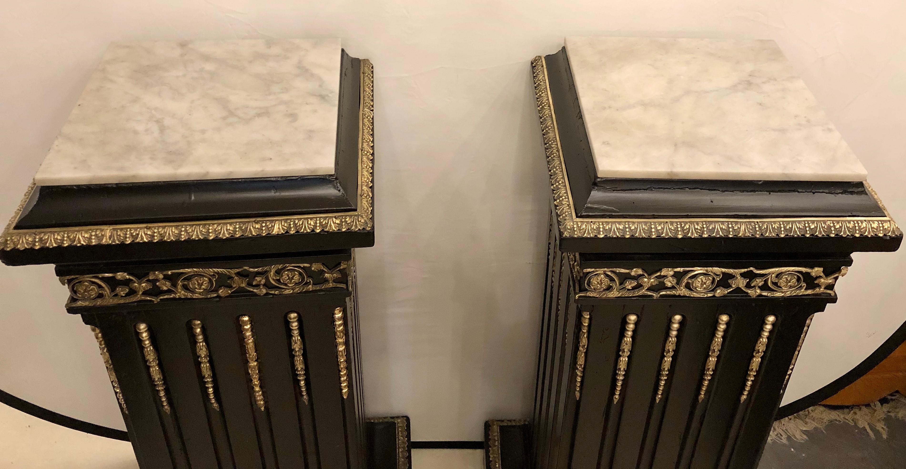 Hollywood Regency Neoclassical Ebony Pedestals, Bronze Mounted Marble Tops, Pair In Good Condition For Sale In Stamford, CT
