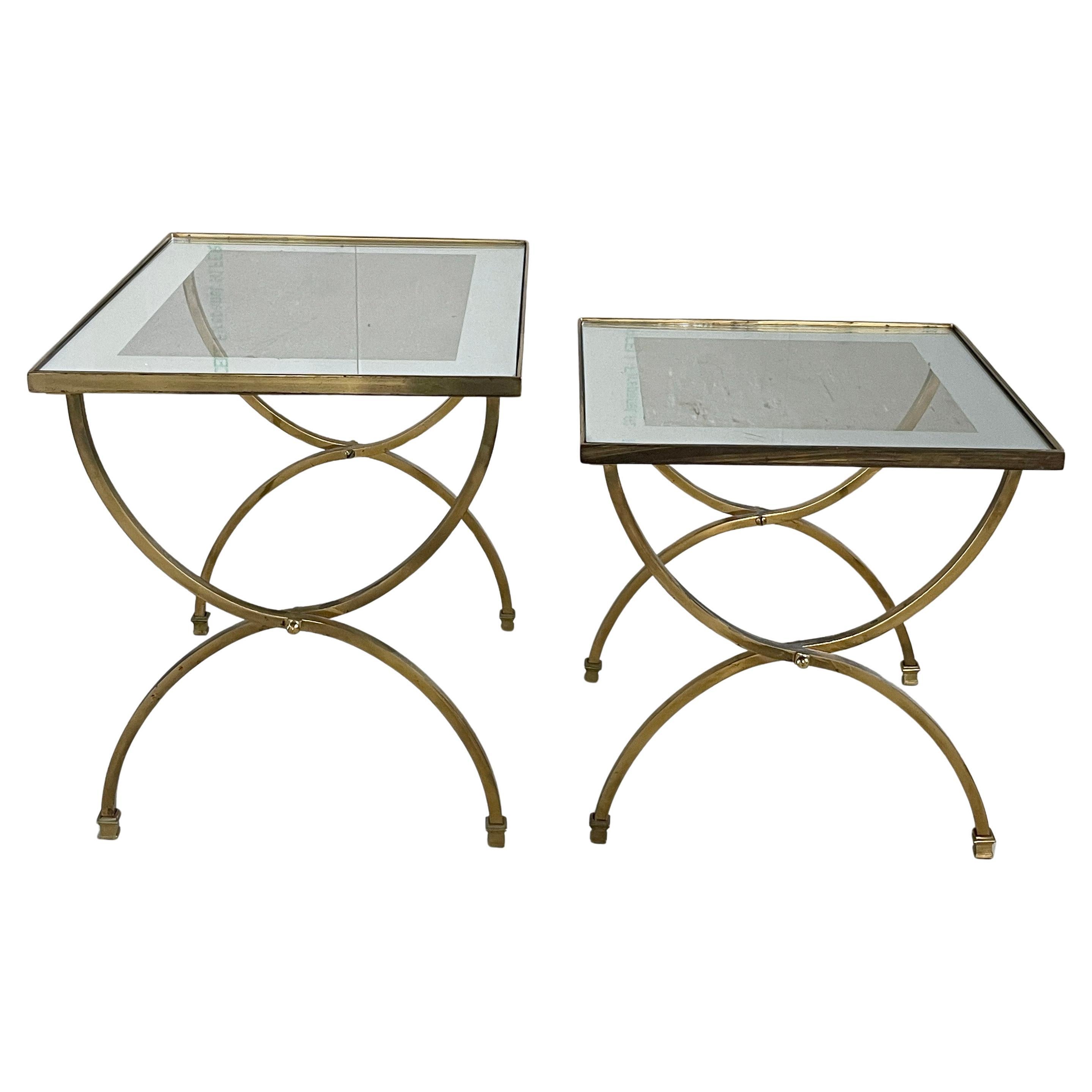 Mid Century brass nesting tables with glass tabletops with mirrored border. Elegant Hollywood Regency style. Believed to be of French origin.
Produced: In the style of Maison Jansen
Measurements: Height: 39 cm  Width: 42cm  Depth: 42cm  
The glass