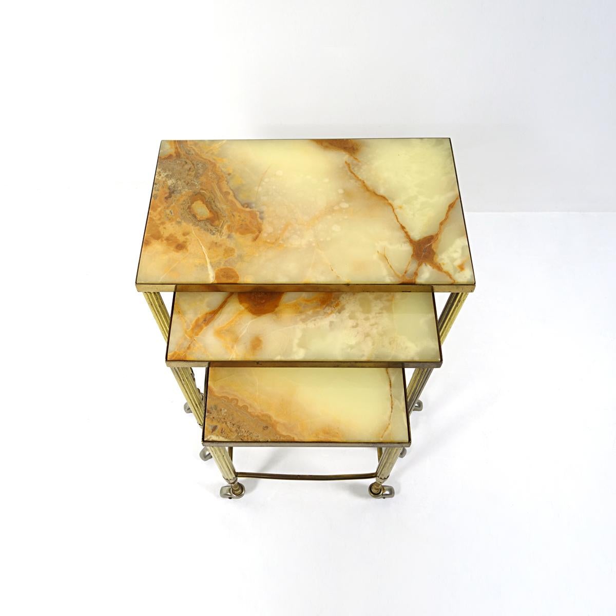 20th Century Hollywood Regency Nesting Tables on Wheels Made of Brass With Marble Tops For Sale