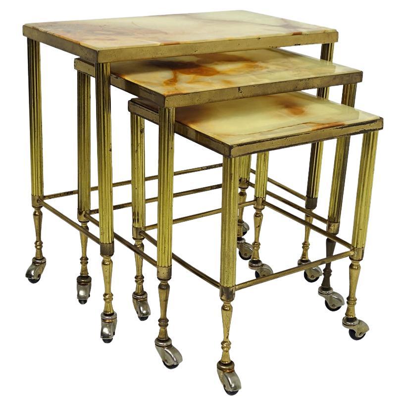Hollywood Regency Nesting Tables on Wheels Made of Brass With Marble Tops For Sale