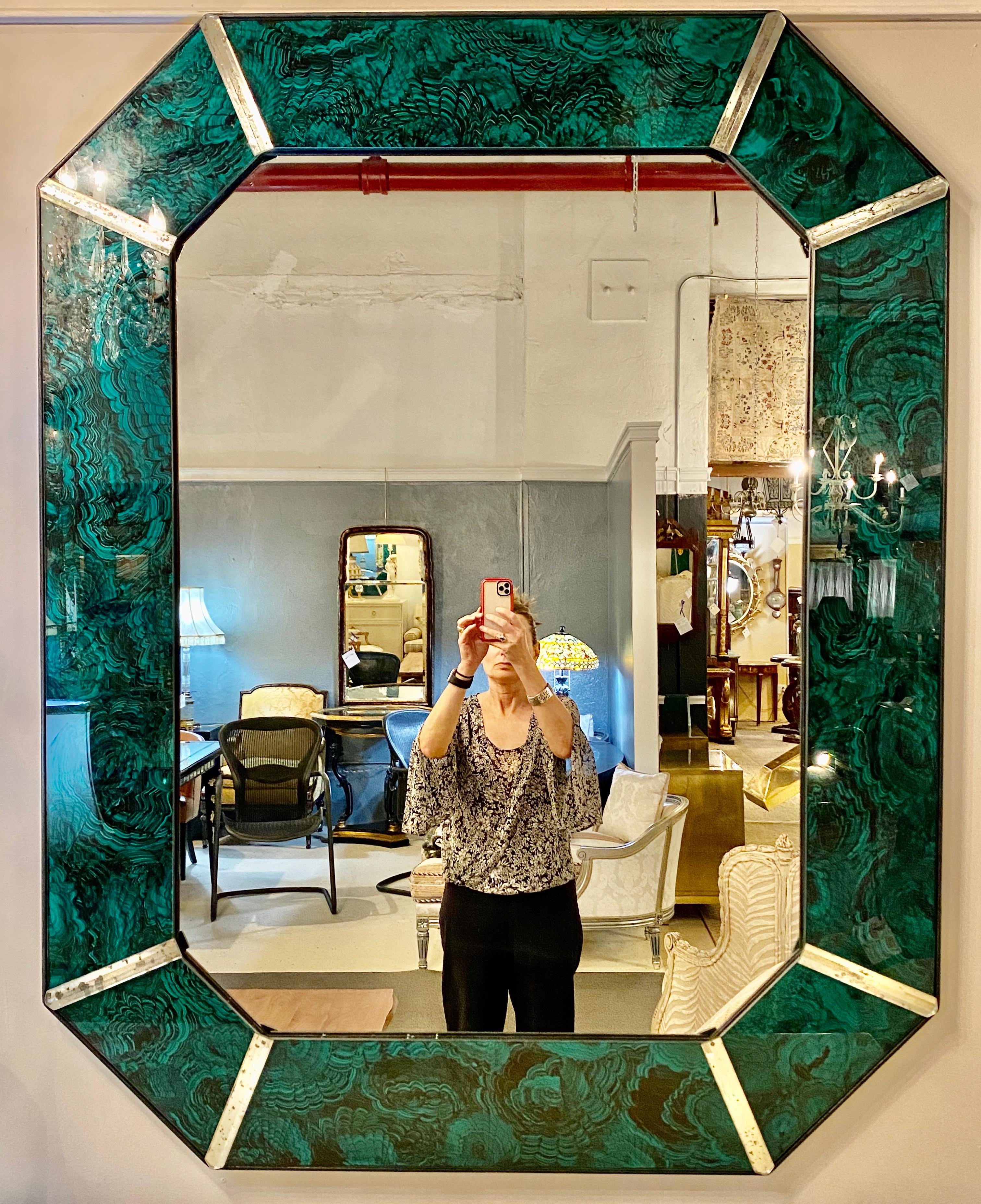 Hollywood Regency octagonal wall, console mirrors. This fine pair of antiqued malachite style stunning mirrors are large and impressive done in the Art Deco style. Each octagonal shaped mirror has and antiqued appearance with a malachite style