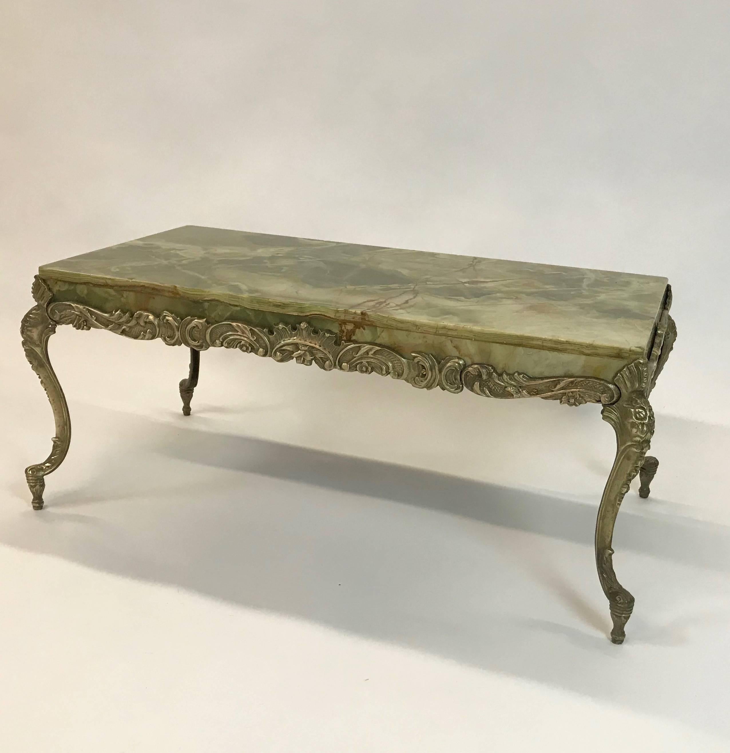 Elegant, Hollywood regency cocktail or coffee table features a jade toned, onyx top with ornate, cast bronze frame with acanthus knees, cabriole legs.