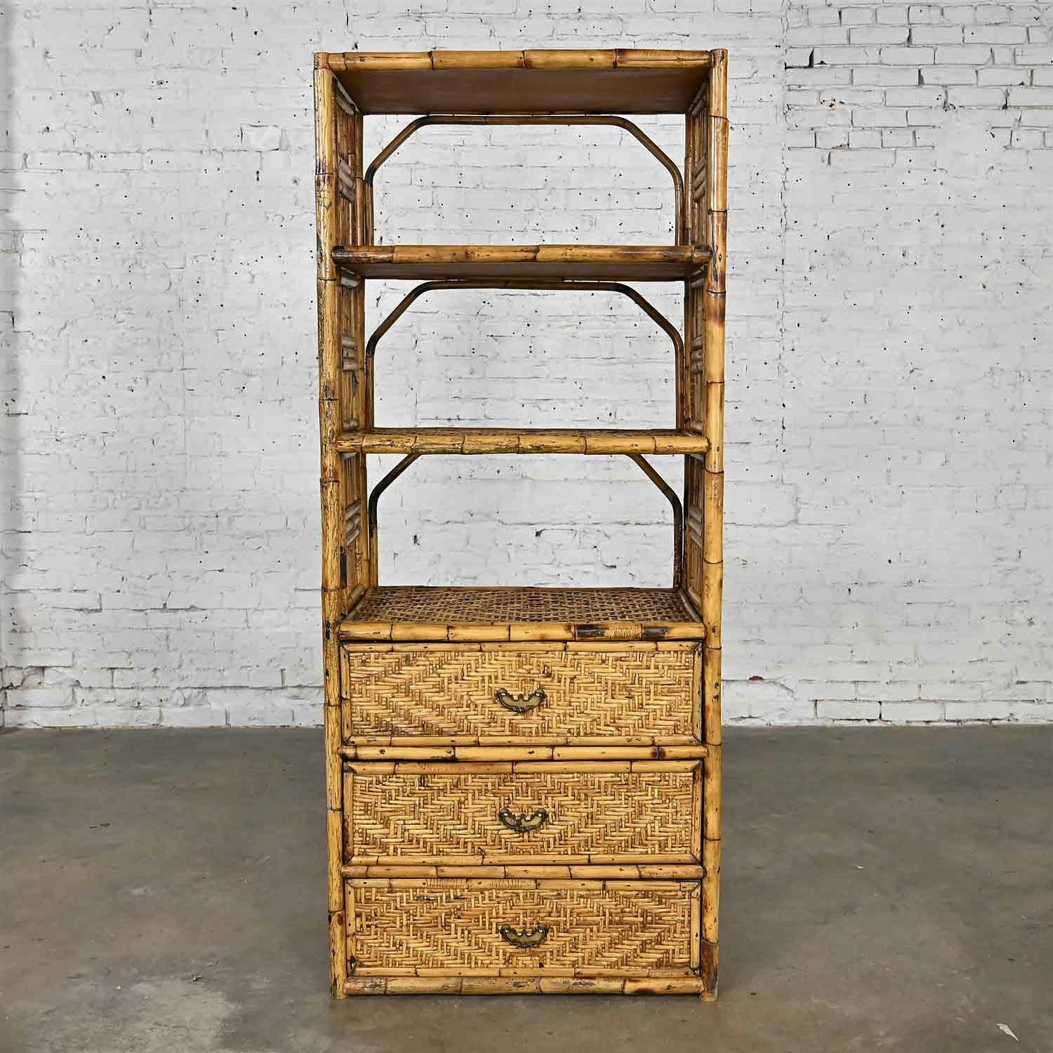 Wonderful vintage Hollywood Regency and Organic Modern rattan etagere or cabinet with brass plated pulls. Beautiful condition, keeping in mind that this is vintage and not new so will have signs of use and wear. Please see photos and zoom in for