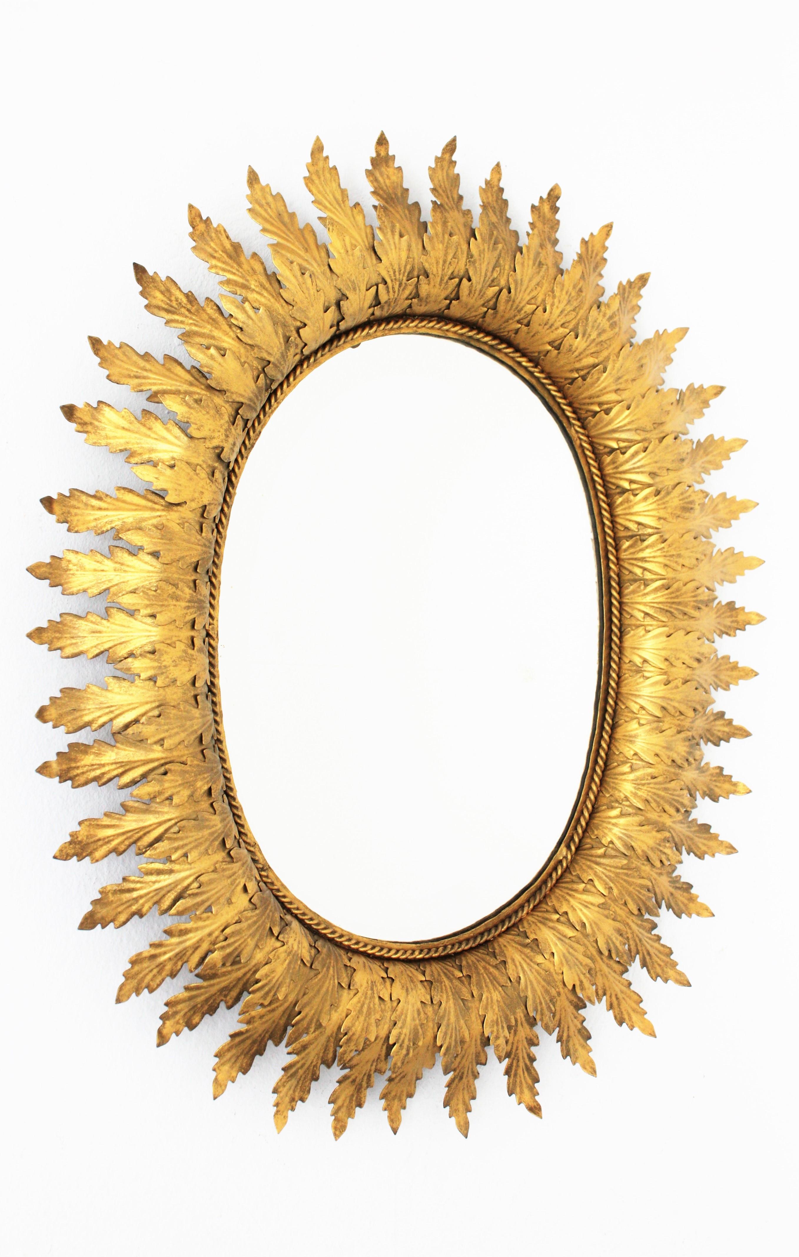 Mid-Century Modern Hollywood Regency Oval Gilt Metal Leafed Sunburst Mirror, Spain, 1950s