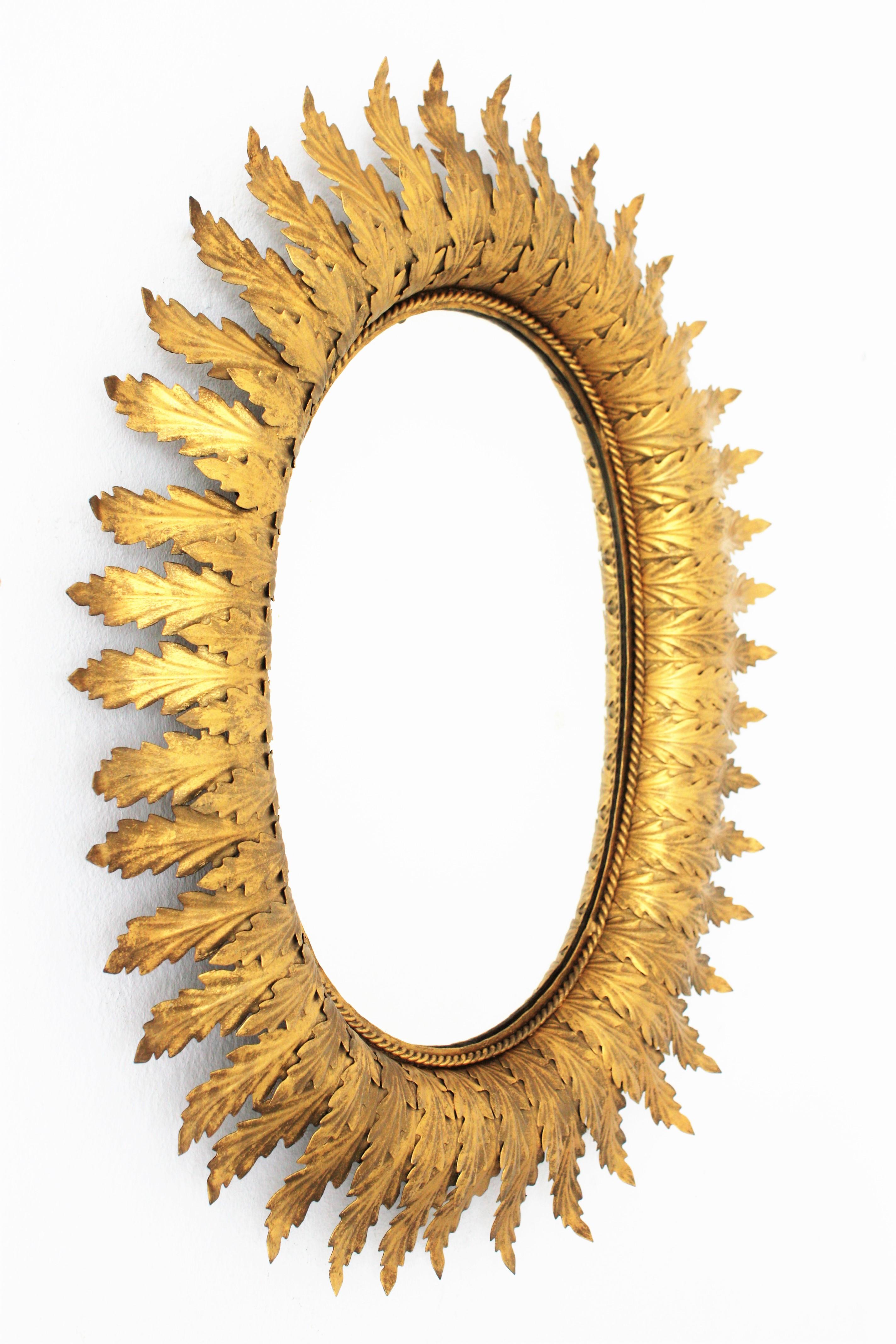 Spanish Hollywood Regency Oval Gilt Metal Leafed Sunburst Mirror, Spain, 1950s