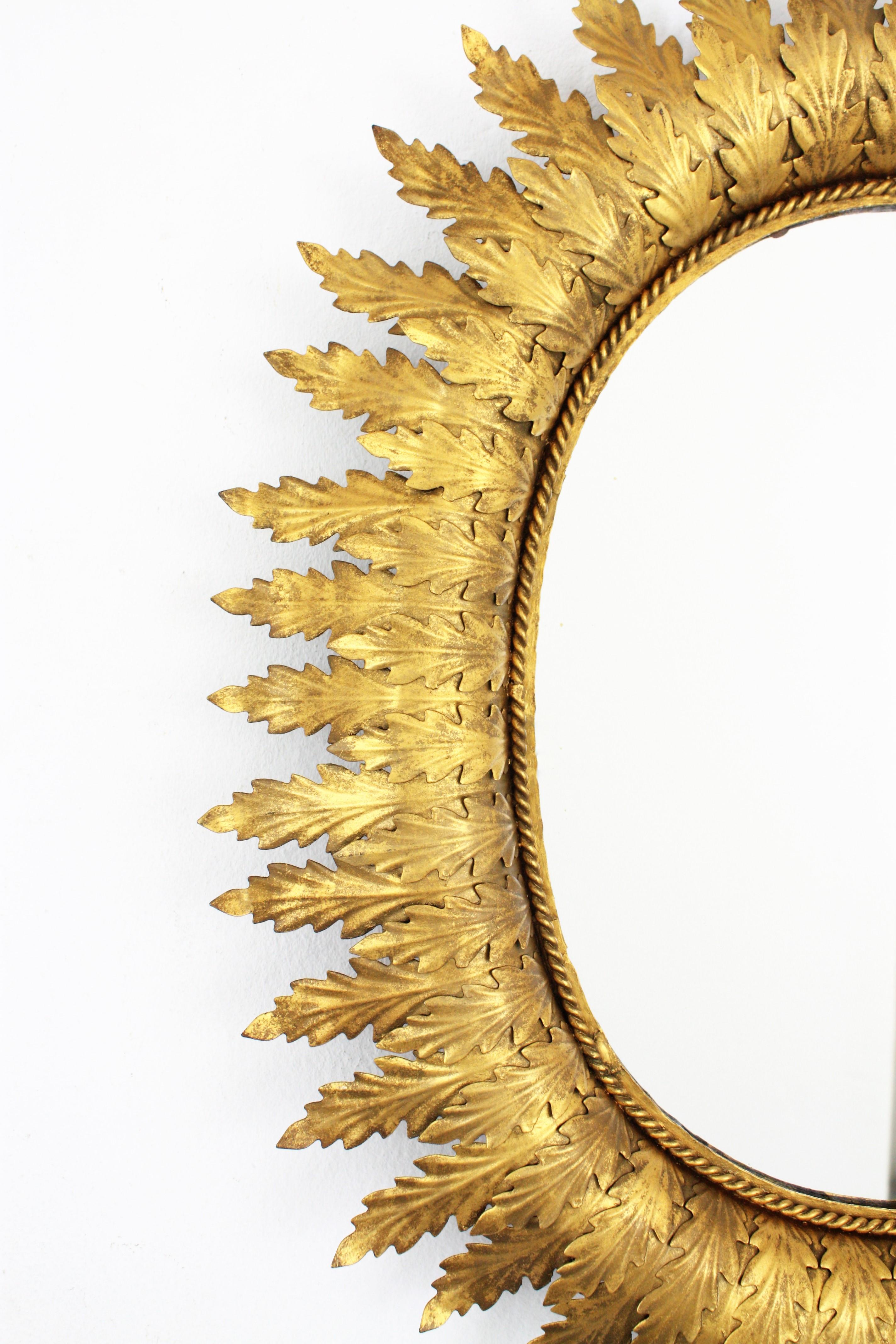 20th Century Hollywood Regency Oval Gilt Metal Leafed Sunburst Mirror, Spain, 1950s