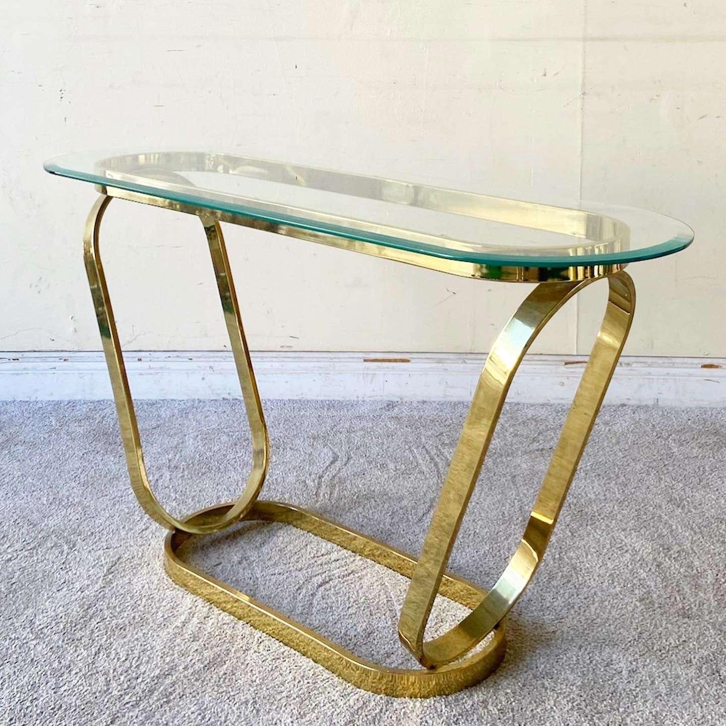 Incredible vintage Hollywood regency console table. Table is comprised of 4 gold finished ovals with a beveled glass top.