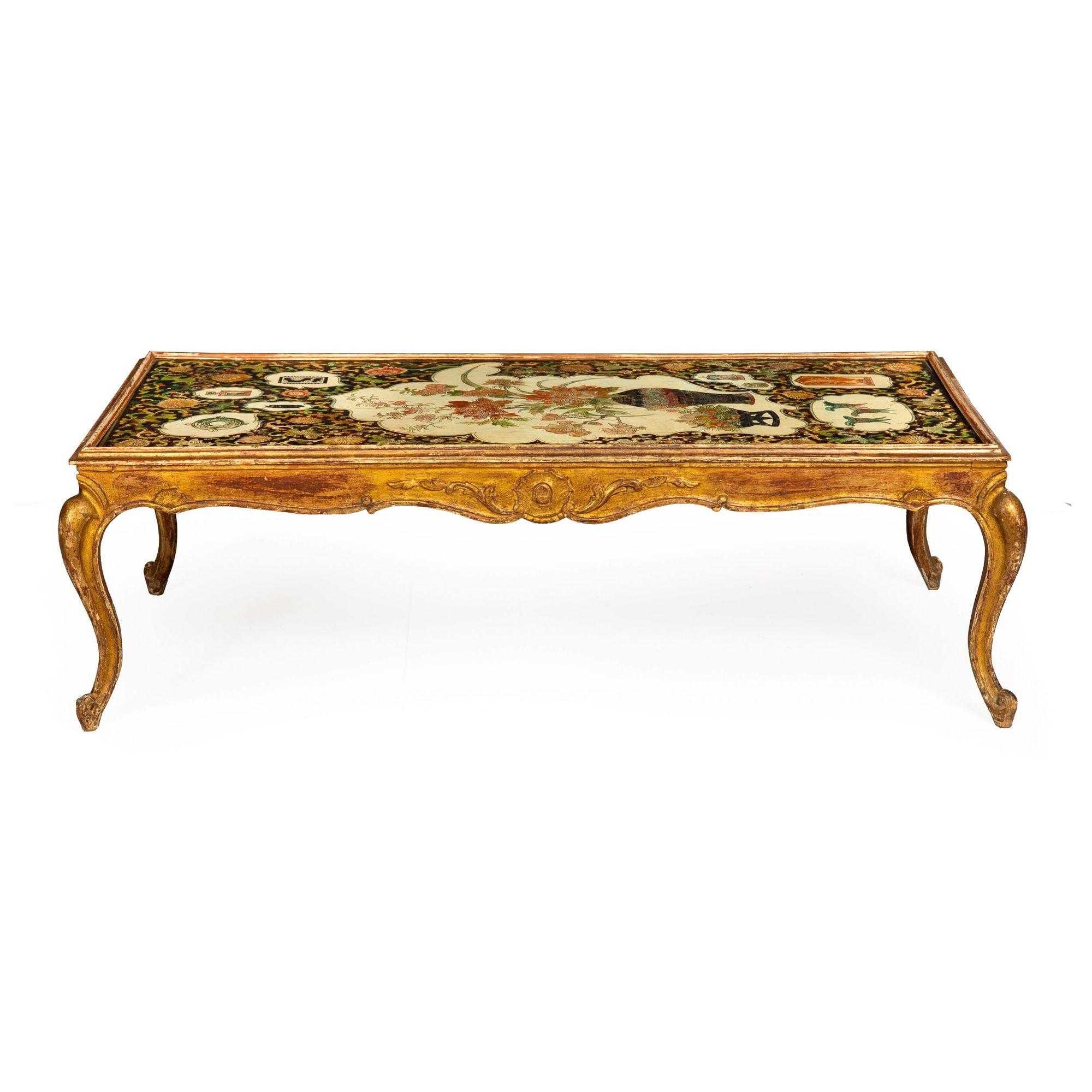 HOLLYWOOD REGENCY GILTWOOD LOW TABLE WITH INCISED POLYCHROME PAINTED TOP
Circa 1940s
Item # 403LVB18M

An exuberant design from the Hollywood Regency era, this fine low coffee table showcases a perfect blend of a subdued elegance and personality.