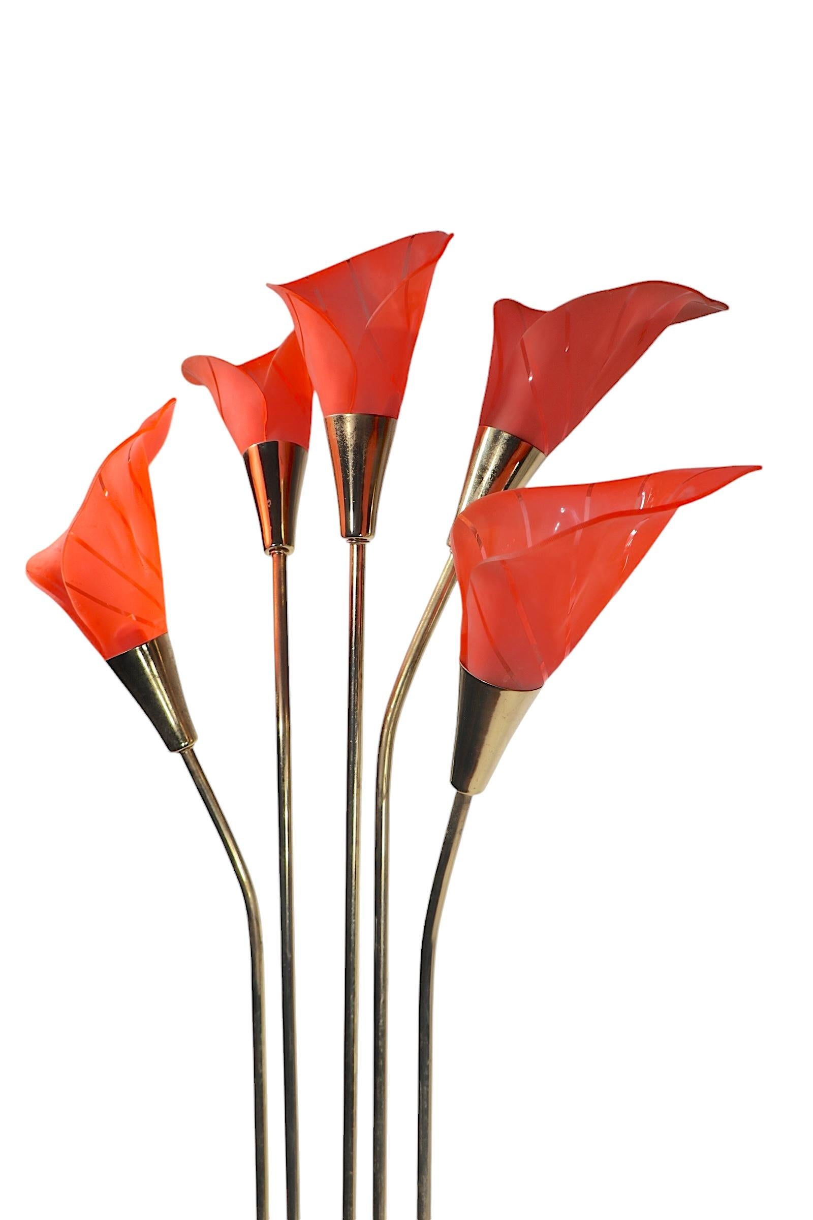 Voguish late 20th C Hollywood Regency, Palm Beach Modern style Calla Lily form floor lamp. The lamp features five rose colored flower form shades of molded plastic, which are supported by brass stems, mounted on a black metal plinth base.  The lamp