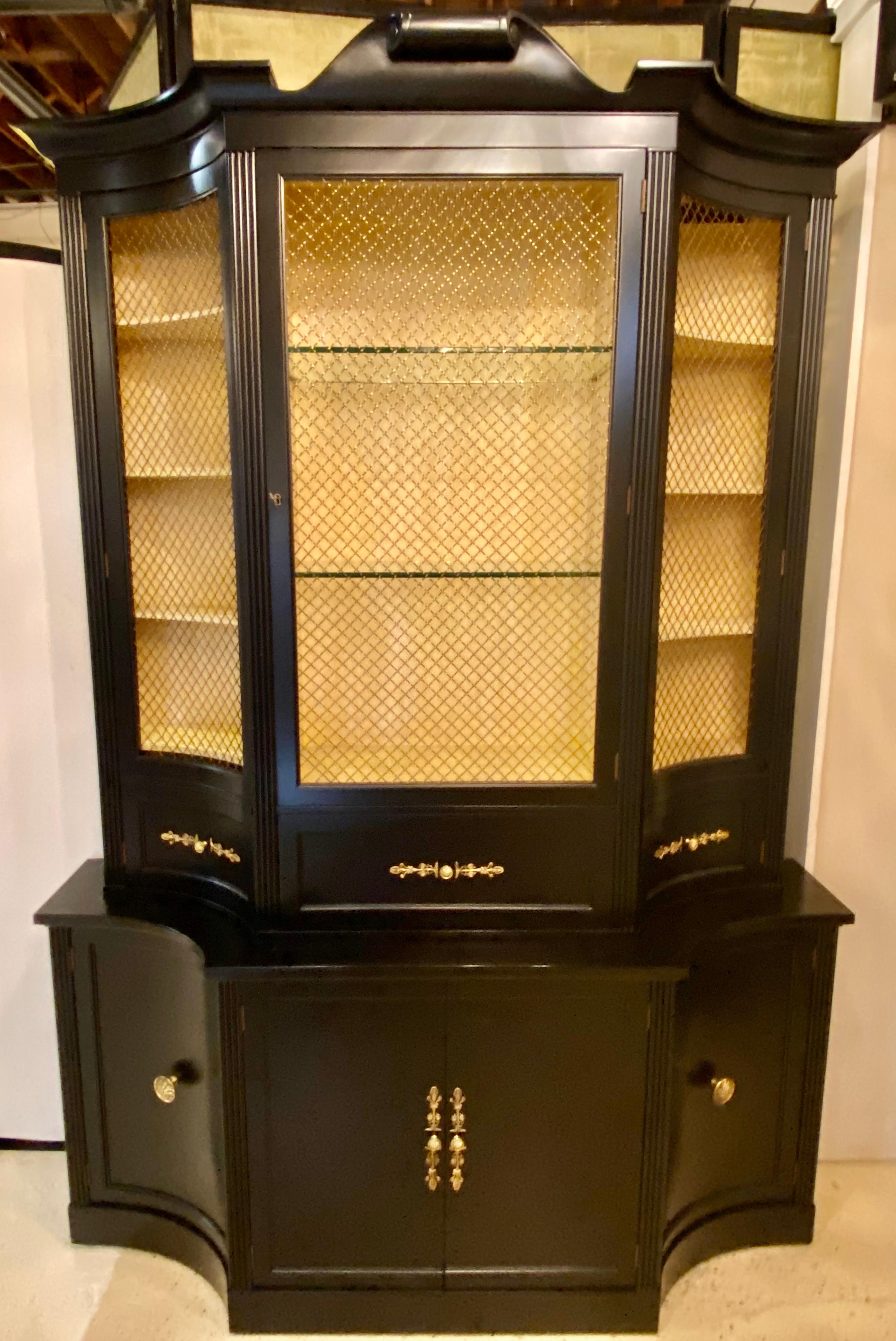 Hollywood Regency Parzinger style cabinet breakfront. Ebony and glass lighted. This fine ebony fully refinished cabinet need only have the interior light rewired. The sideboard, server base having concave sides with double front doors all with