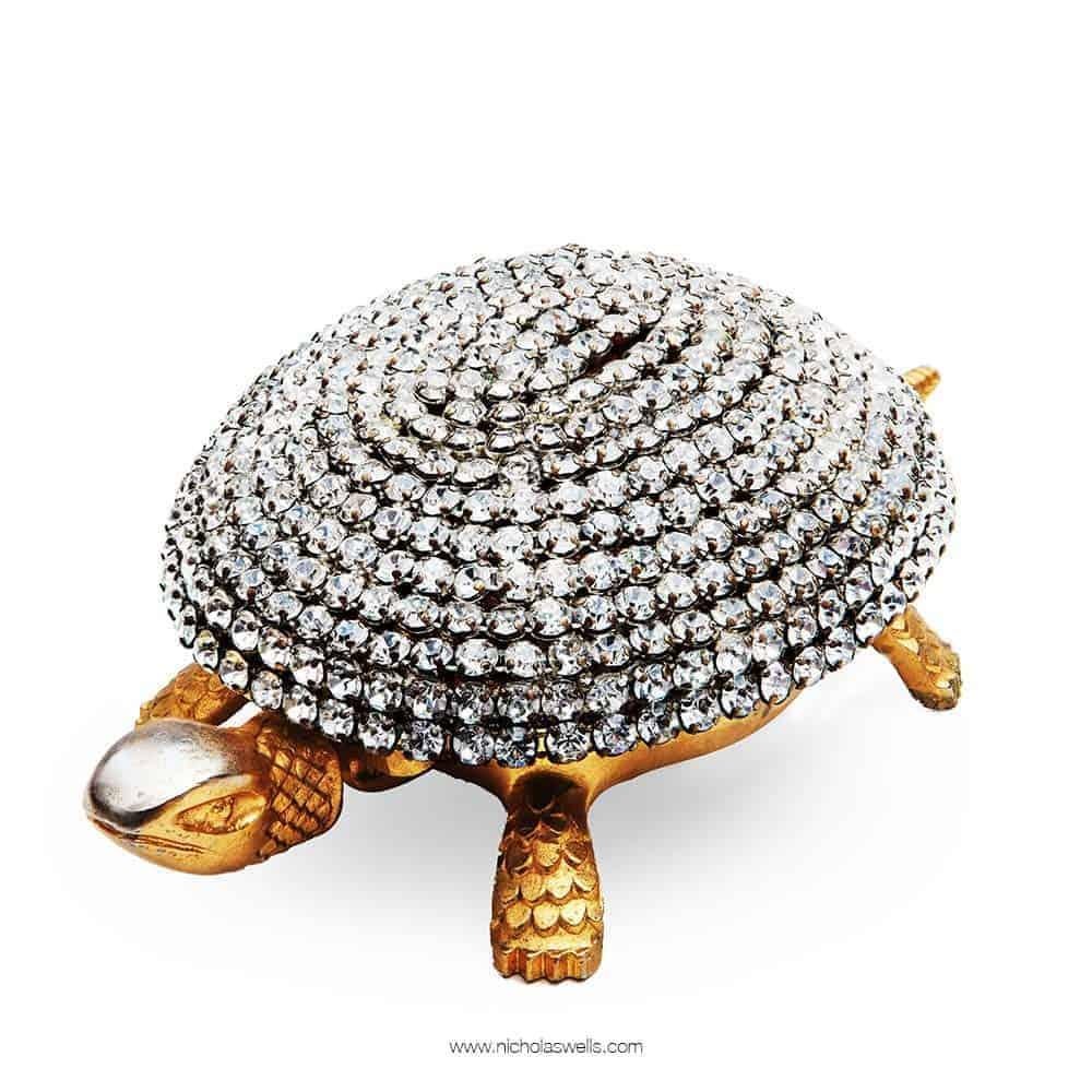A very unusual and rare mid-20th century Toledo gilt tortoise bell, the top unusually covered in paste diamonds.

Measures: Length 6 inches 15cm
Depth 3 1/2inches 9cm
Height 2 inches 5cm.