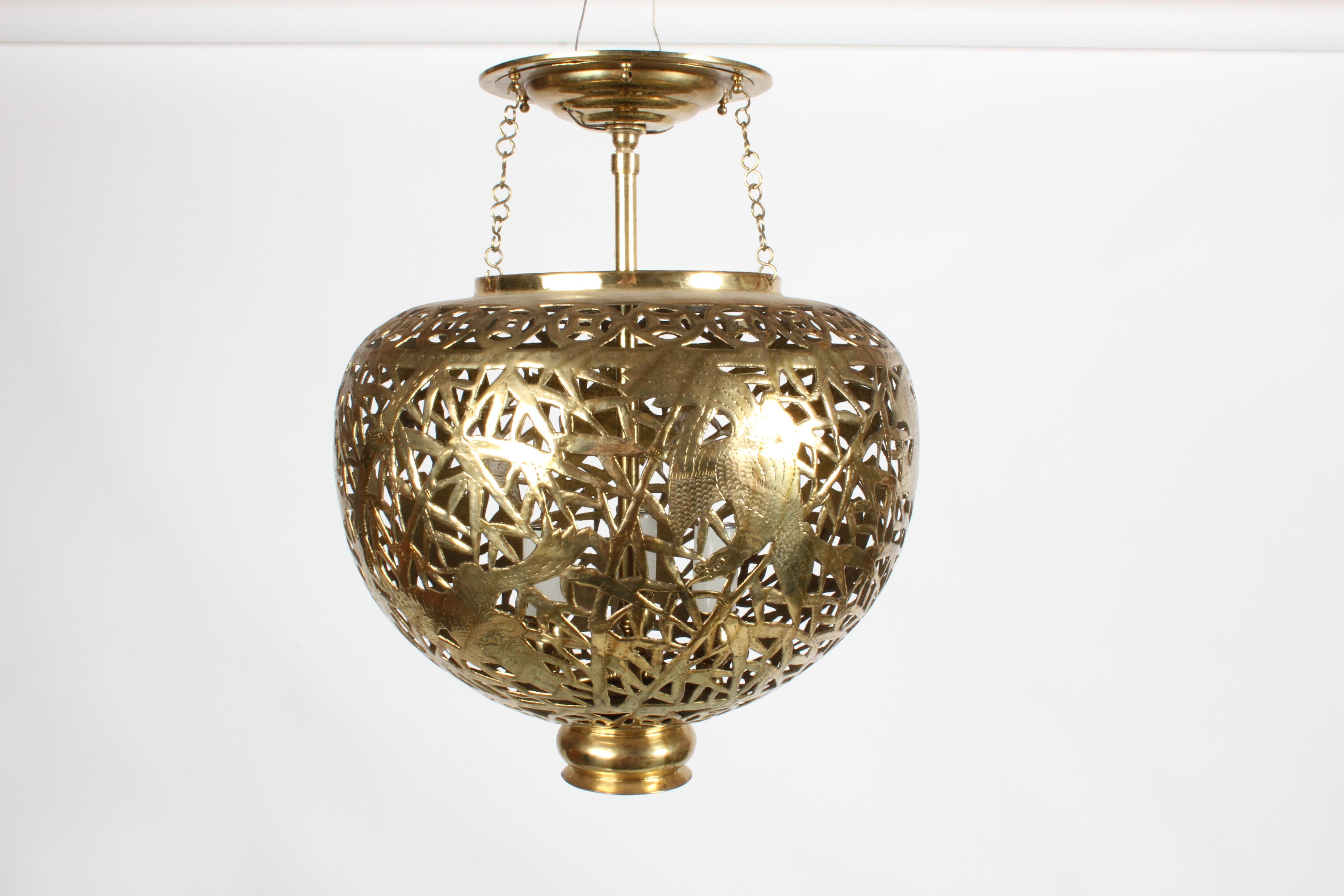 Hollywood Regency brass pendant chandelier with Asian theme. Faux bamboo filigree design with a large Asian, Japanese or Chinese character and pheasants, stamped Hong Kong. Suspended three arm internal light fixture is accessible by removing brass