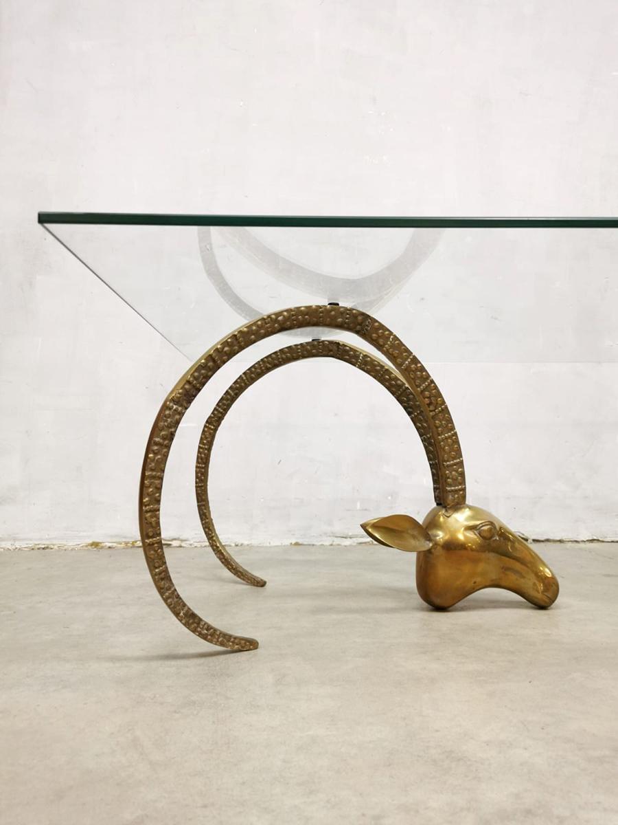 This pair of Hollywood Regency brass animal head coffee table bases are attributed to Alain Chervet, France. These heavy ram, mouflon or ibex head bases in brass have their original patina with a new hand waxed finish, are accented with beautiful