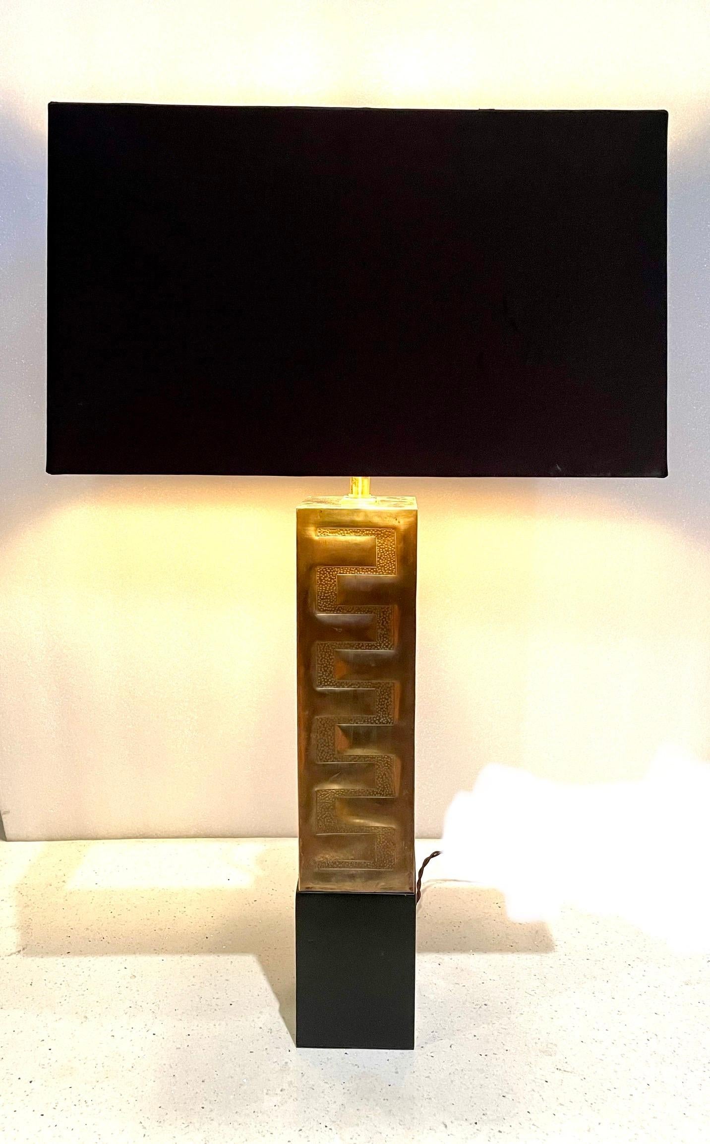 Striking one-of-a-kind lamp polished brass base sitting on black lacquer wood base, freshly rewired the shade its included and measures 16