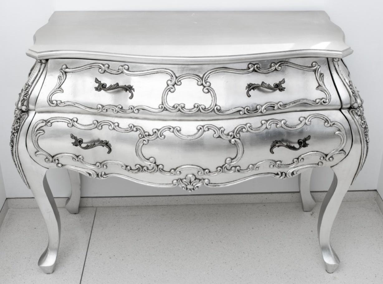 Pair of platinum leaf Hollywood Regency Rococo Revival two-drawer commodes, with shaped tops above confirming bombe bodies on 4 cabriole legs. 33