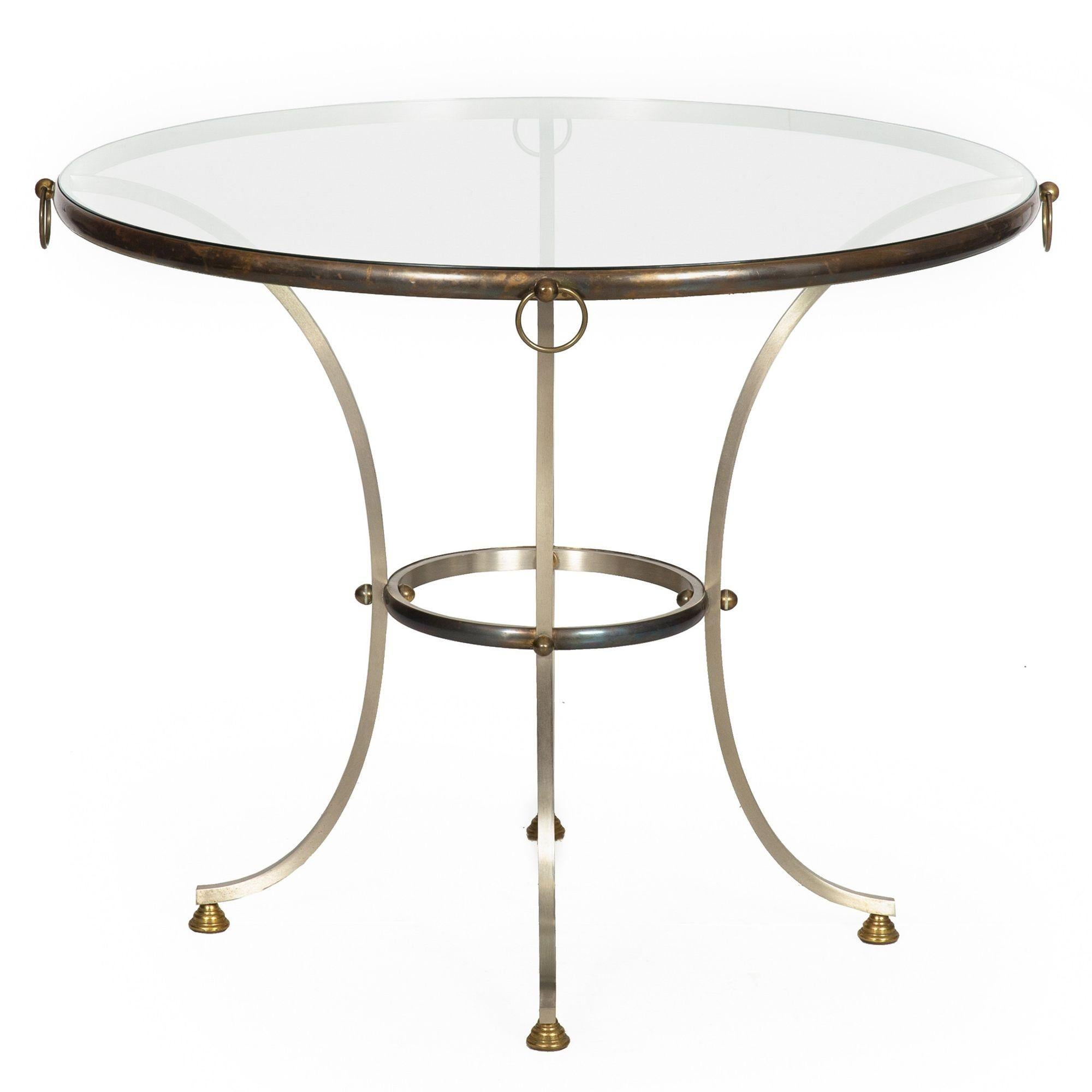 HOLLYWOOD REGENCY BRUSHED STEEL, BRONZE, BRASS AND GLASS CENTER TABLE
Probably Italian circa 1970s  manner of Maison Jansen  unmarked
Item # 311XGP10P

An absolutely gorgeous vintage Hollywood Regency style circular center table, it features a glass