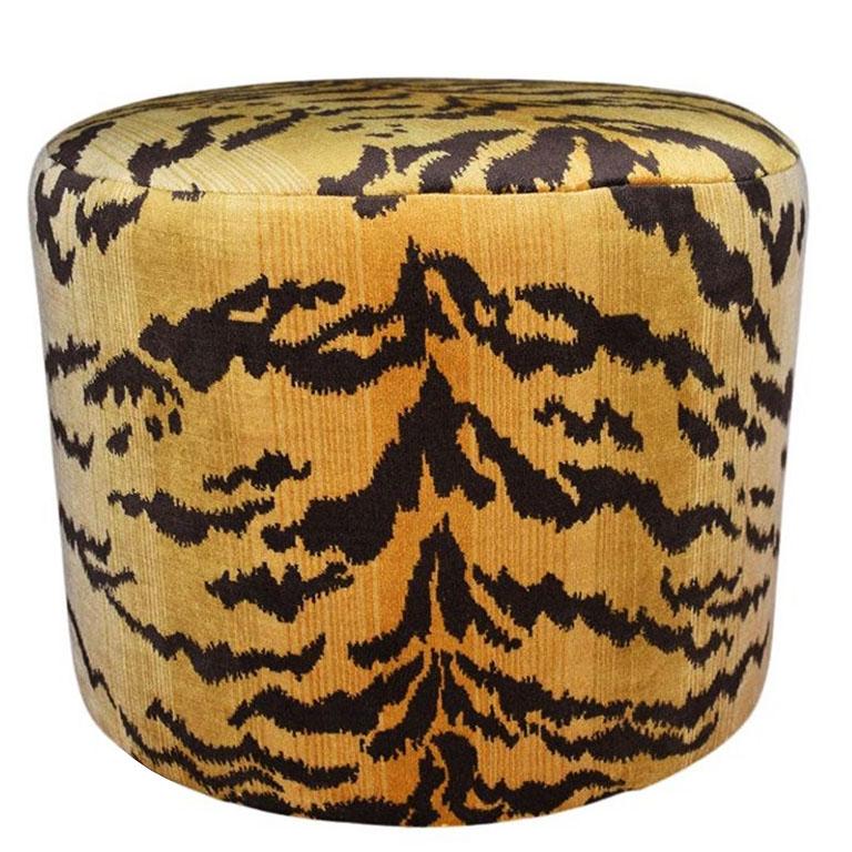 A stunning Hollywood Regency style hand crafted ottoman, covered in rich le Tigre velvet. Round in form, each stool is created by hand by our in house craftsman, and covered in a thick velvet tiger print fabric brought from Belgium. Each stool sits