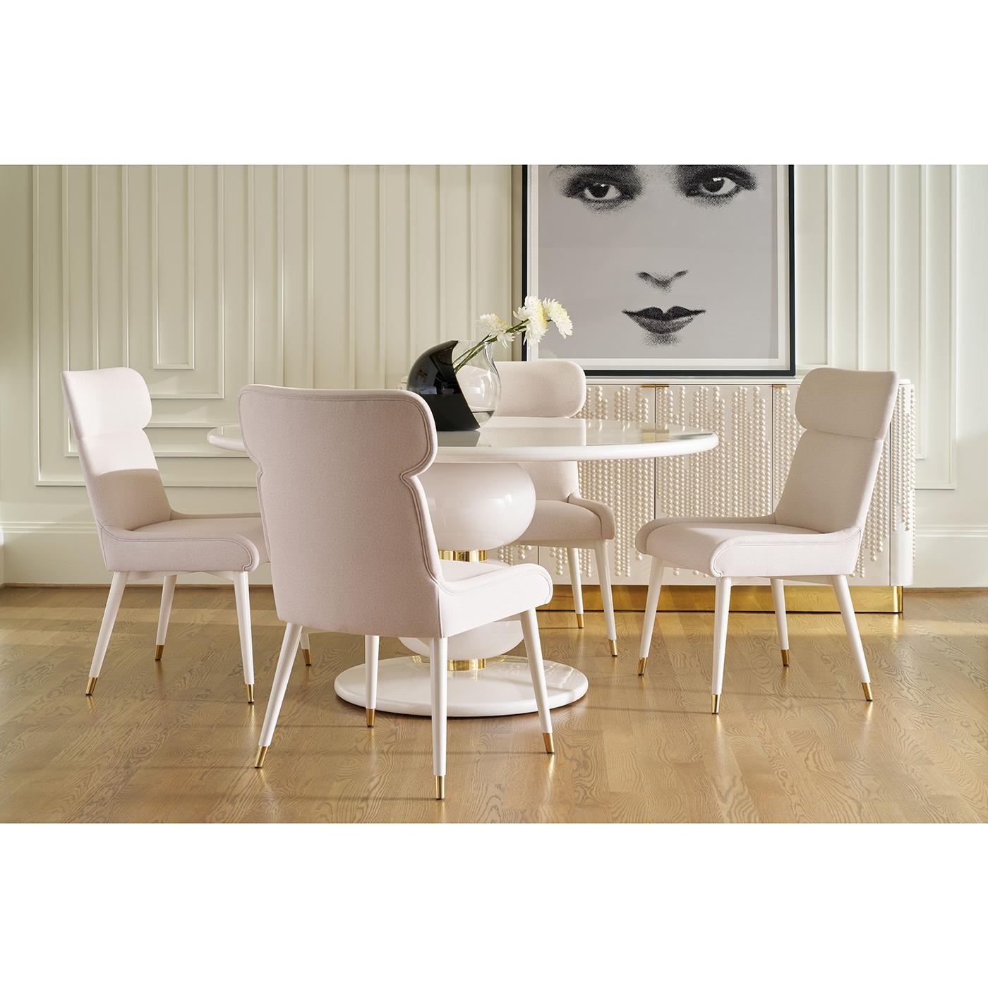 Dining Table brings bold glamour and sculptural form to contemporary dining. Made from quartz with polished brass accents, it features a rounded pedestal base formed by two stacked spheres, separated by gleaming brass bands and resting on a circular