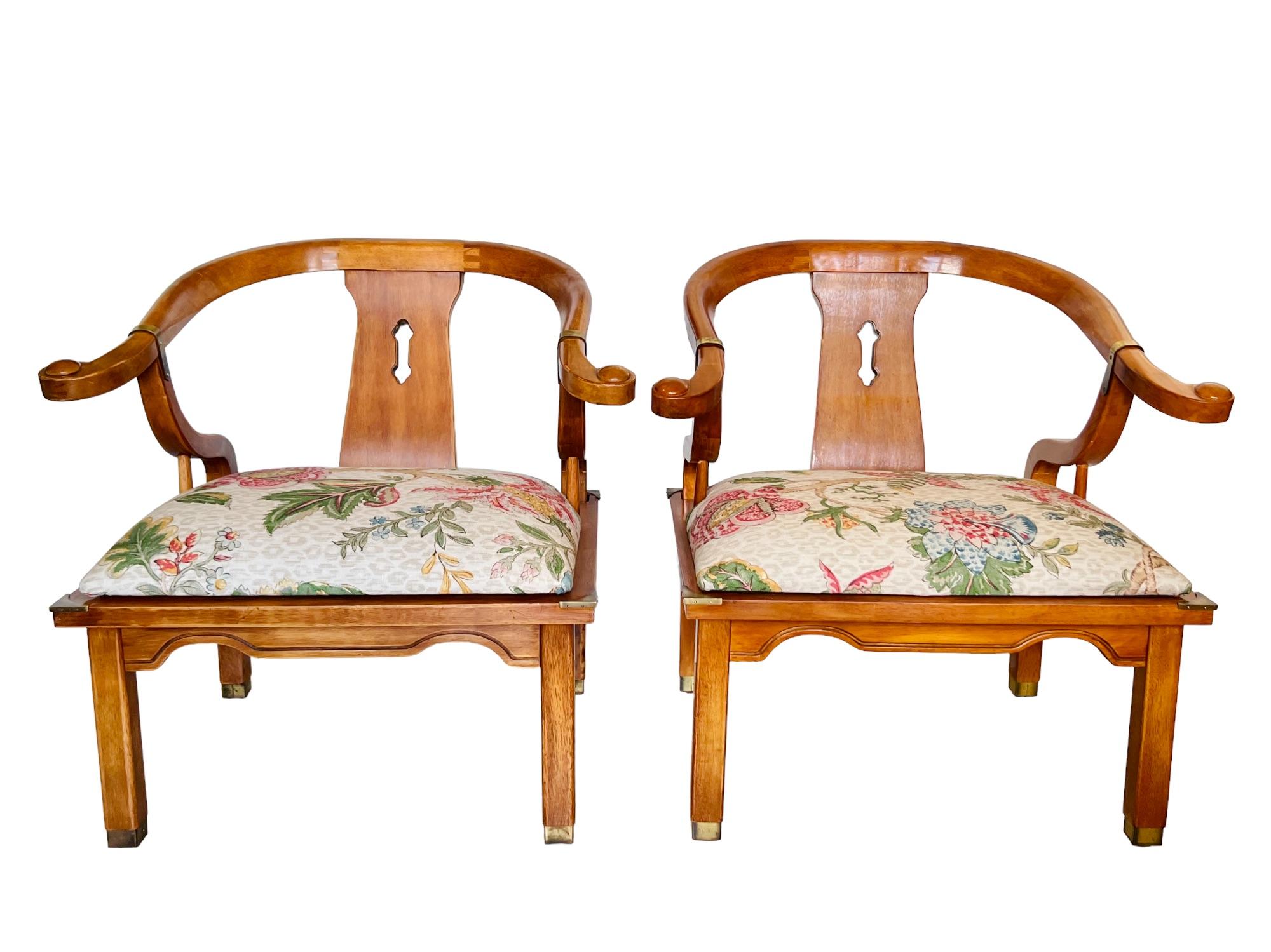 A late 20th century pair of chinoiserie Ming style yoke back horseshoe chairs by Schnadig. Wood frames with brass details on armrests, seat corners and feet. Woven cotton/linen blend fabric featuring tone on tone bisque leopard pattern with vibrant