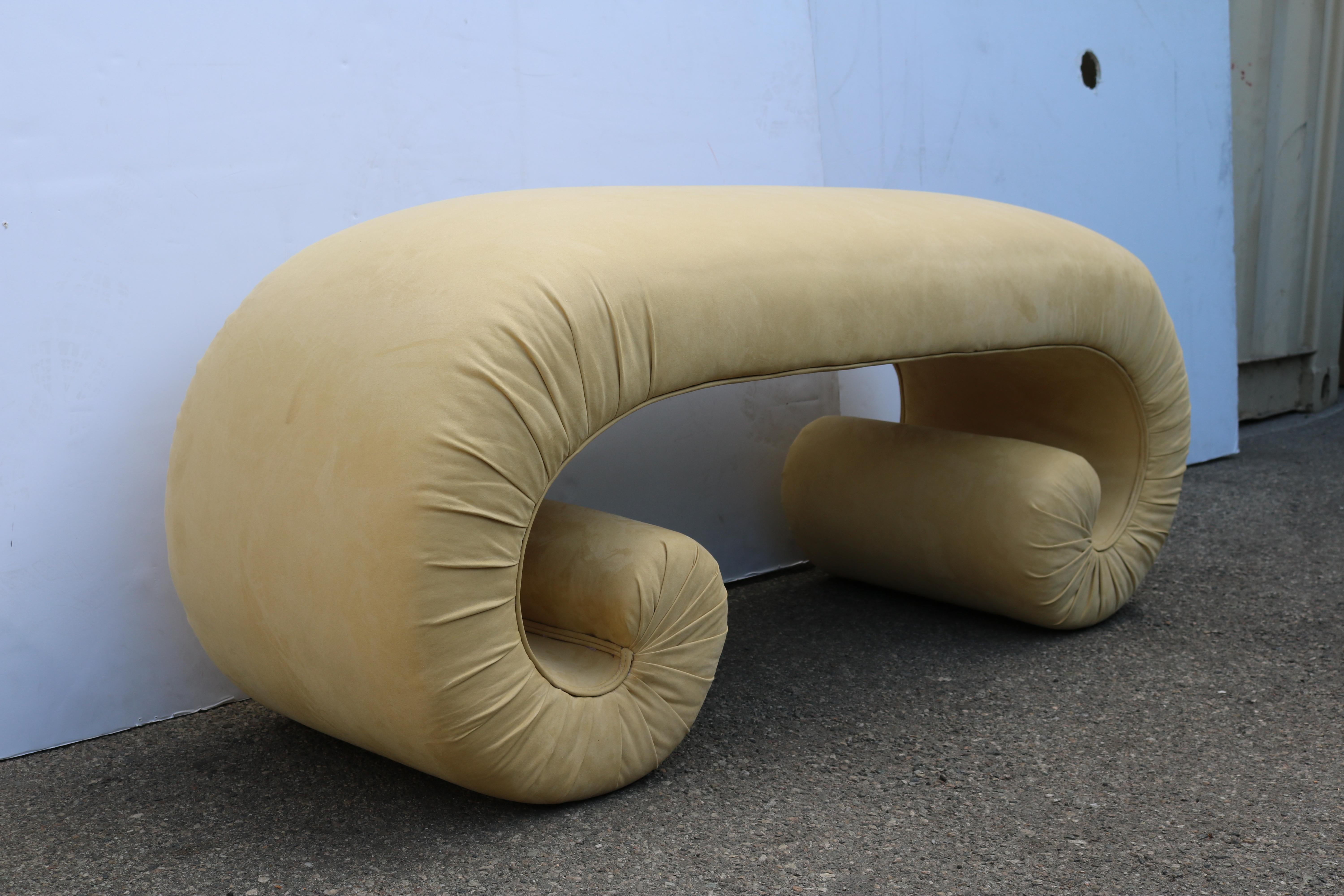This whimsical and comfy bench, with its scroll legs has been reupholstered in suede leather.
Its shape reminds Karl Springer coffee tables's design.

