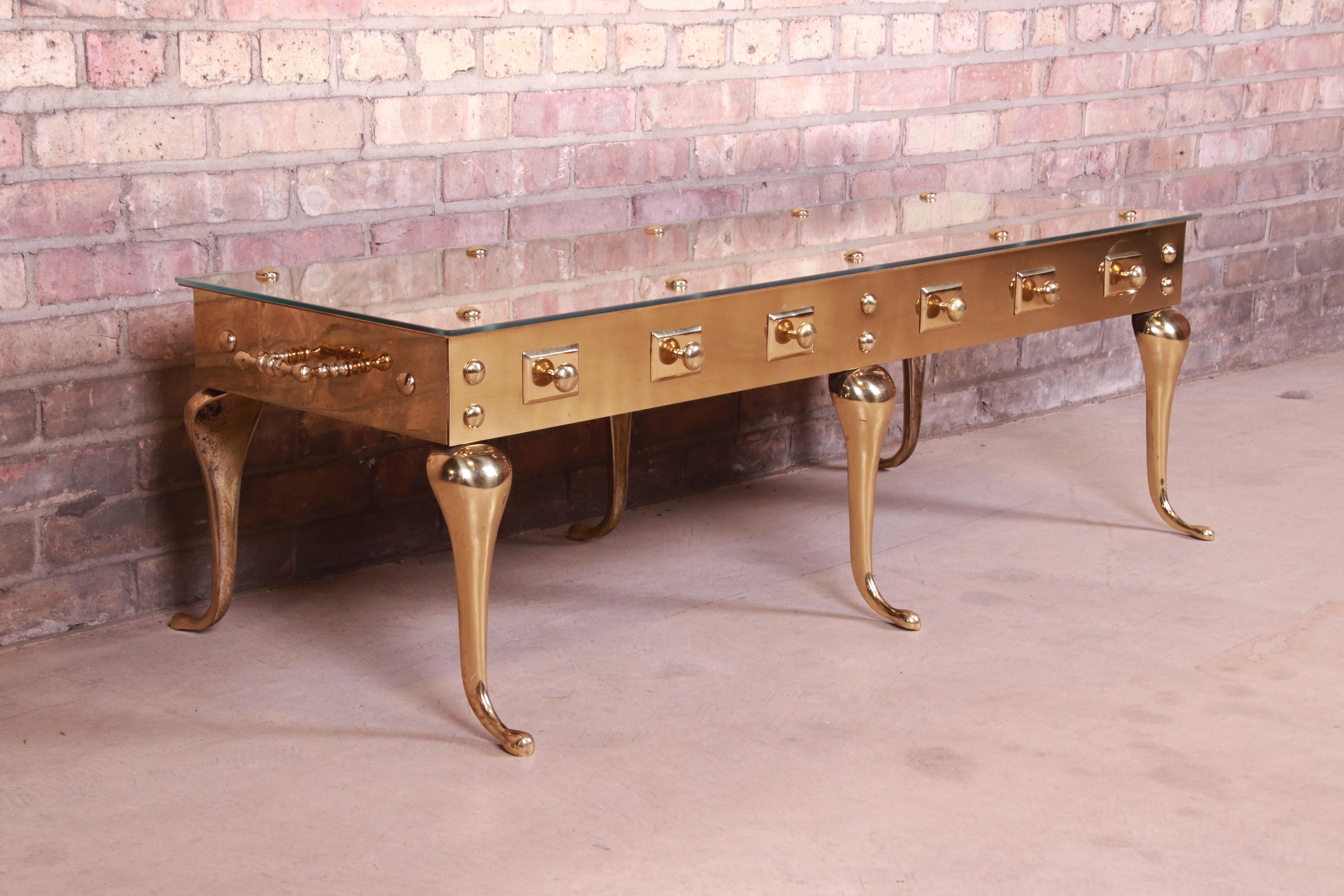 A gorgeous mid-century Hollywood Regency coffee or cocktail table

Attributed to Labarge,

Circa 1960s

Solid sculpted brass frame with glass top.

Measures: 51.5