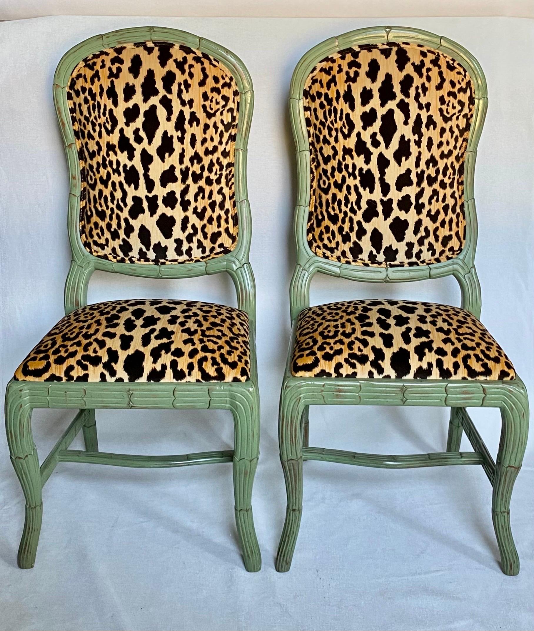 Fabulous Hollywood Regency Serge Roche style carved palm armless chairs newly upholstered in a graphic animal print cotton velvet fabric. These sculptural chairs feature a dimensional and incredibly detailed carved wood palm tree design with