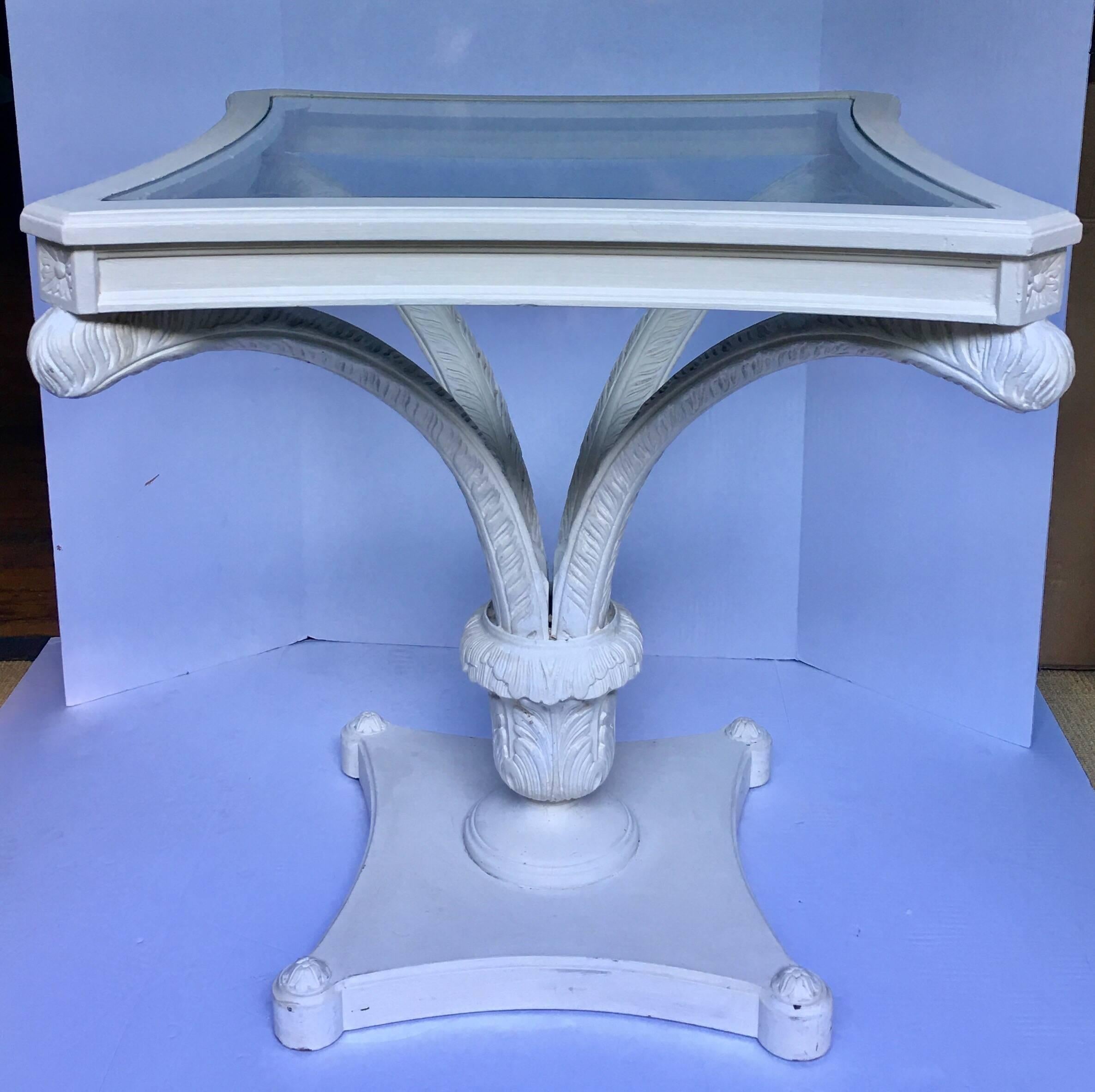 Palm Regency carved wood and glass table featuring a detailed palm leaf frond or ostrich feather motif in the style of Serge Roche. Plaster-like matte white painted finish. A very versatile piece that could be used as a centre table, side table, or