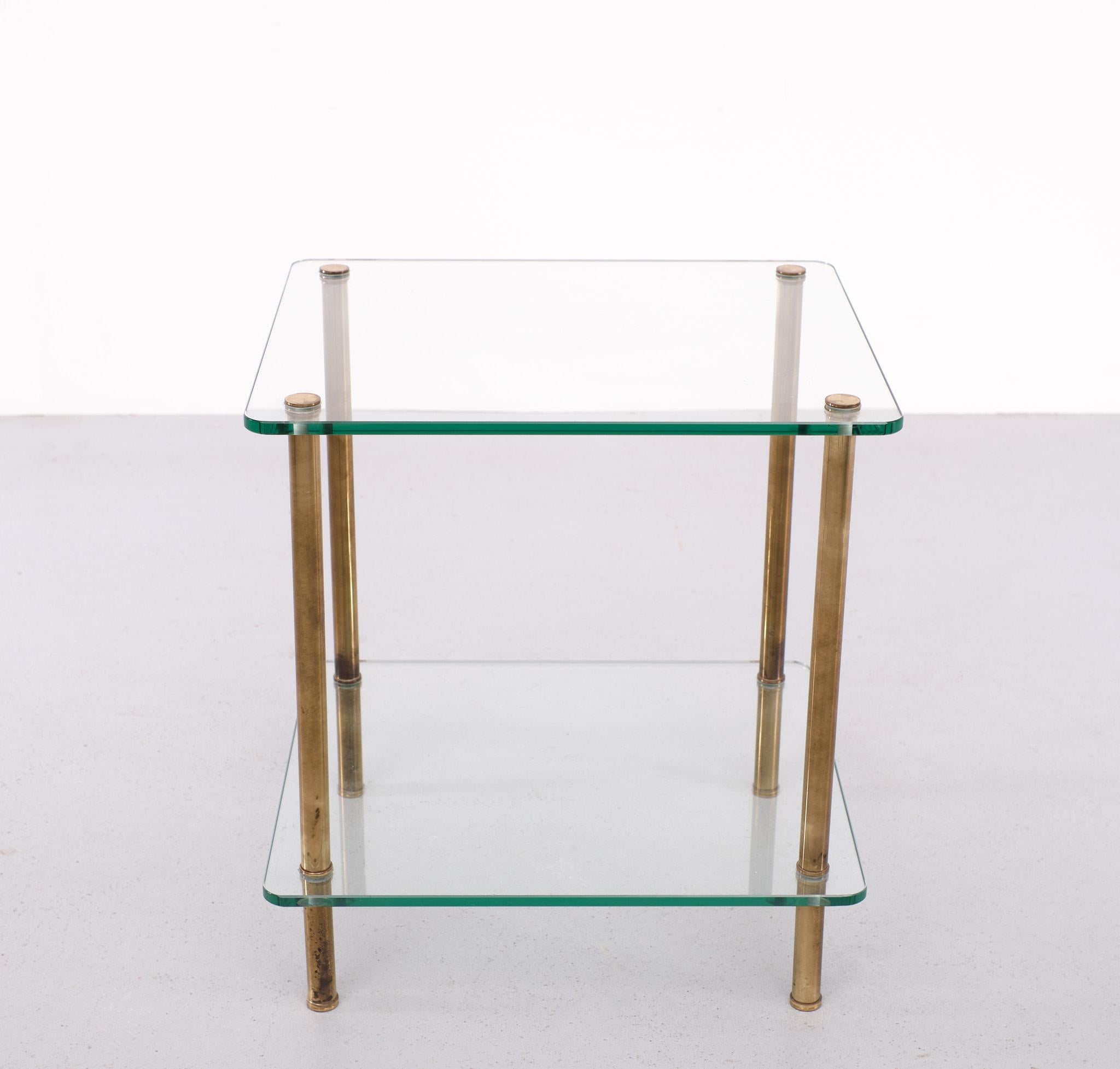 Very nice Two Tier side table . Patinated Brass legs comes with Greenish 
Glass tops . Adjustable feet . Very good quality table .  