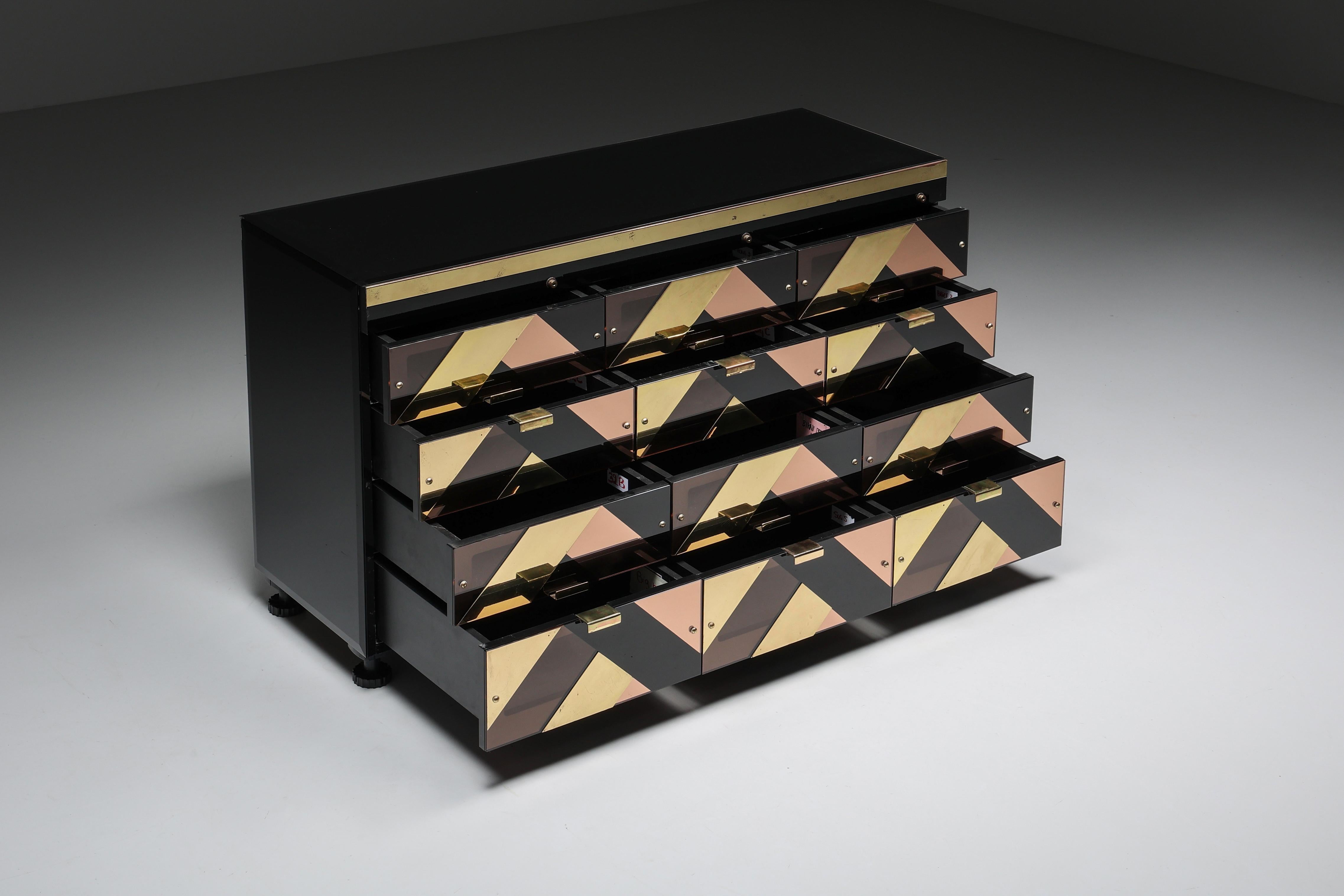 Brass; Smoked Perspex; Black Glass; Drawers; Credenza; Italian Design; Italy; Hollywood Regency; Black & Gold; Sideboard; 

This credenza, a 12-drawer high-end storage piece, is custom-made. Black hyalith glass sides and top. The drawers' fronts are