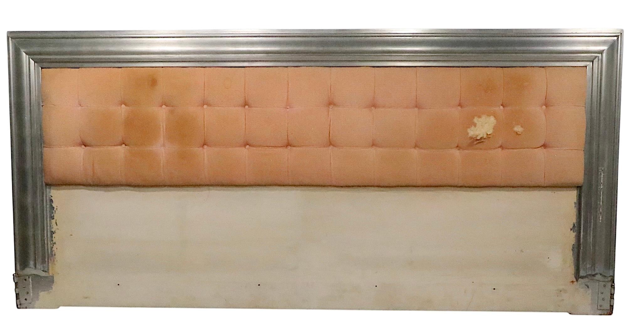 Exceptional Hollywood Regency style king size headboard designed by James Mont, made in the USA, circa 1940's. The headboard features a silver gilt frame edge, which surrounds an upholstered center panel. The bed is extremely well constructed,