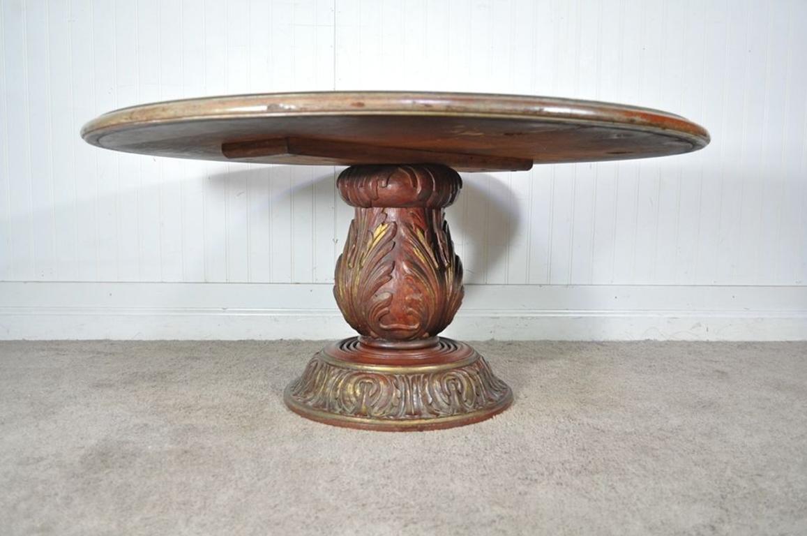 Very unique vintage carved wood pedestal base and distressed eglomise silver leaf mirrored round coffee table. The glass top is beautifully decorated and the overall finish of the table is antiqued/distressed which adds great old world character.