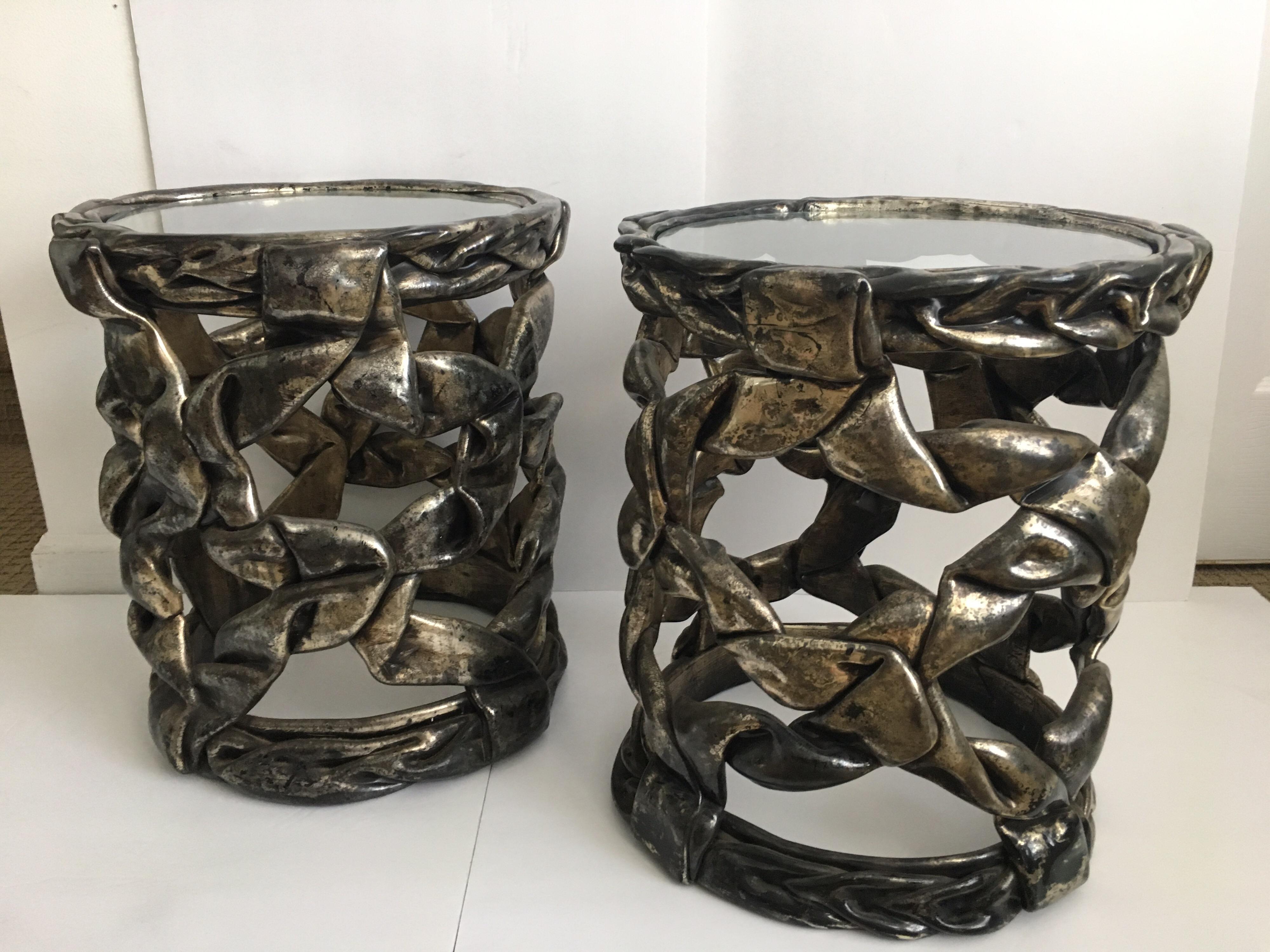 Pair of delicious candy ribbon occasional side tables in the Hollywood Regency style of Tony Duquette. Can be placed together to make an interesting center cocktail table grouping. Original silver leaf finish with natural patina showing gunmetal
