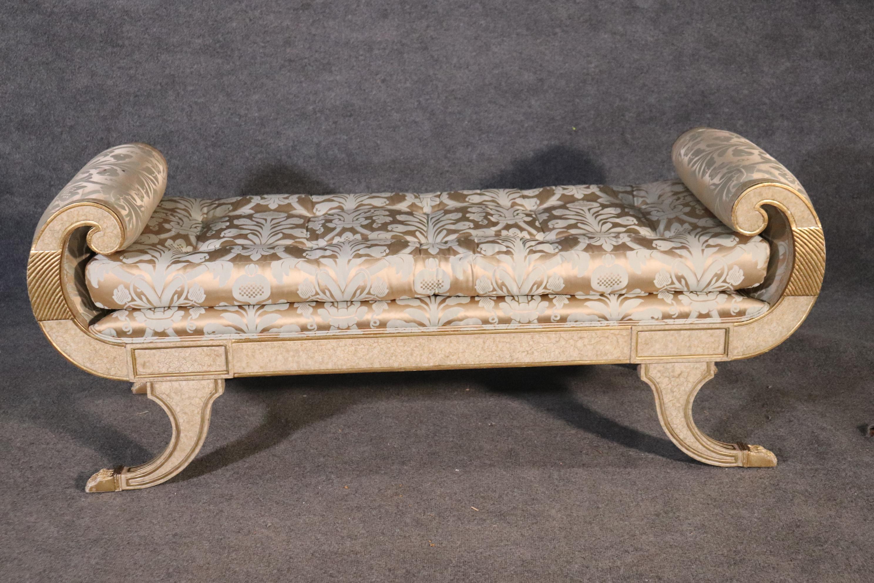 This is a fantastic silver leafed gilded crème painted chaise or window bench. The piece is in good condition but will show some signs of wear and stains from use. The bench measures 56 wide x 20 deep x 22 tall and the seat height is 18 inches tall.
