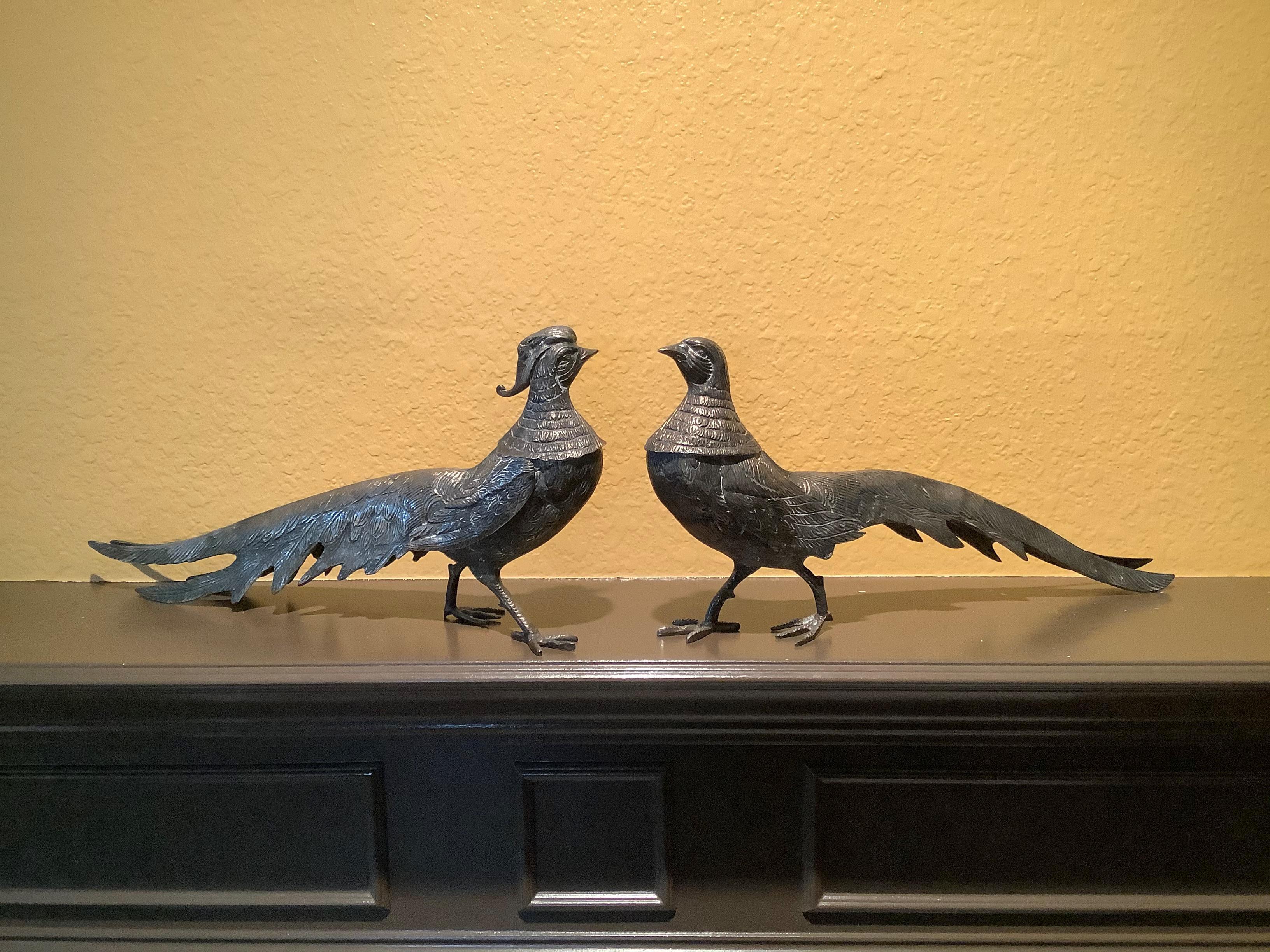 A stunning one-of-a-kind pair of unusually large, silver-plated peacocks -- Great for a mantle, holiday table centerpiece, coffee table, or even as bookends. This pair of birds is classic Hollwood Regency! They are each unique from one-another with