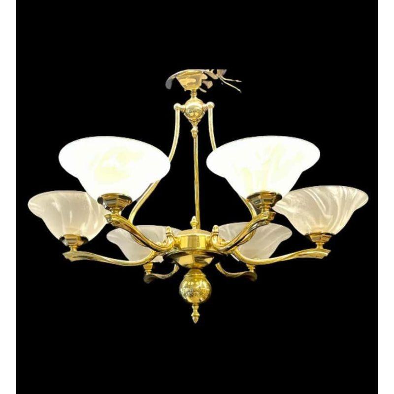Hollywood Regency style six light chandelier. Brass and Alabaster make up this stunning chandelier having six lighted arms all covered in decorative alabaster shades on a finely polished brass frame. Each globe is colored and swirl decorated.