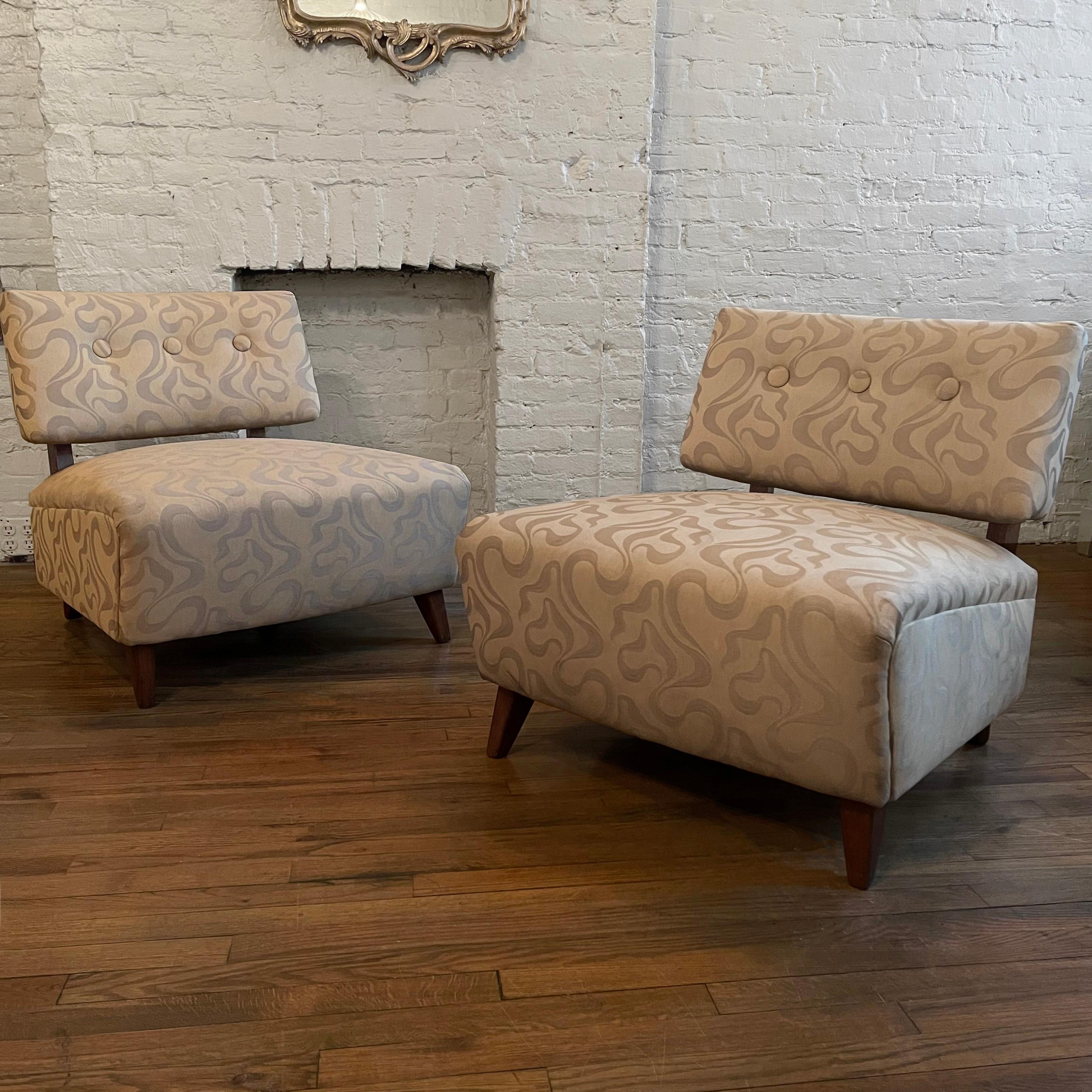 Pair of oversized, midcentury, Hollywood regency, slipper chairs in the style of Billy Haines with walnut frames are upholstered in beige linen, ribbon motif jacquard.