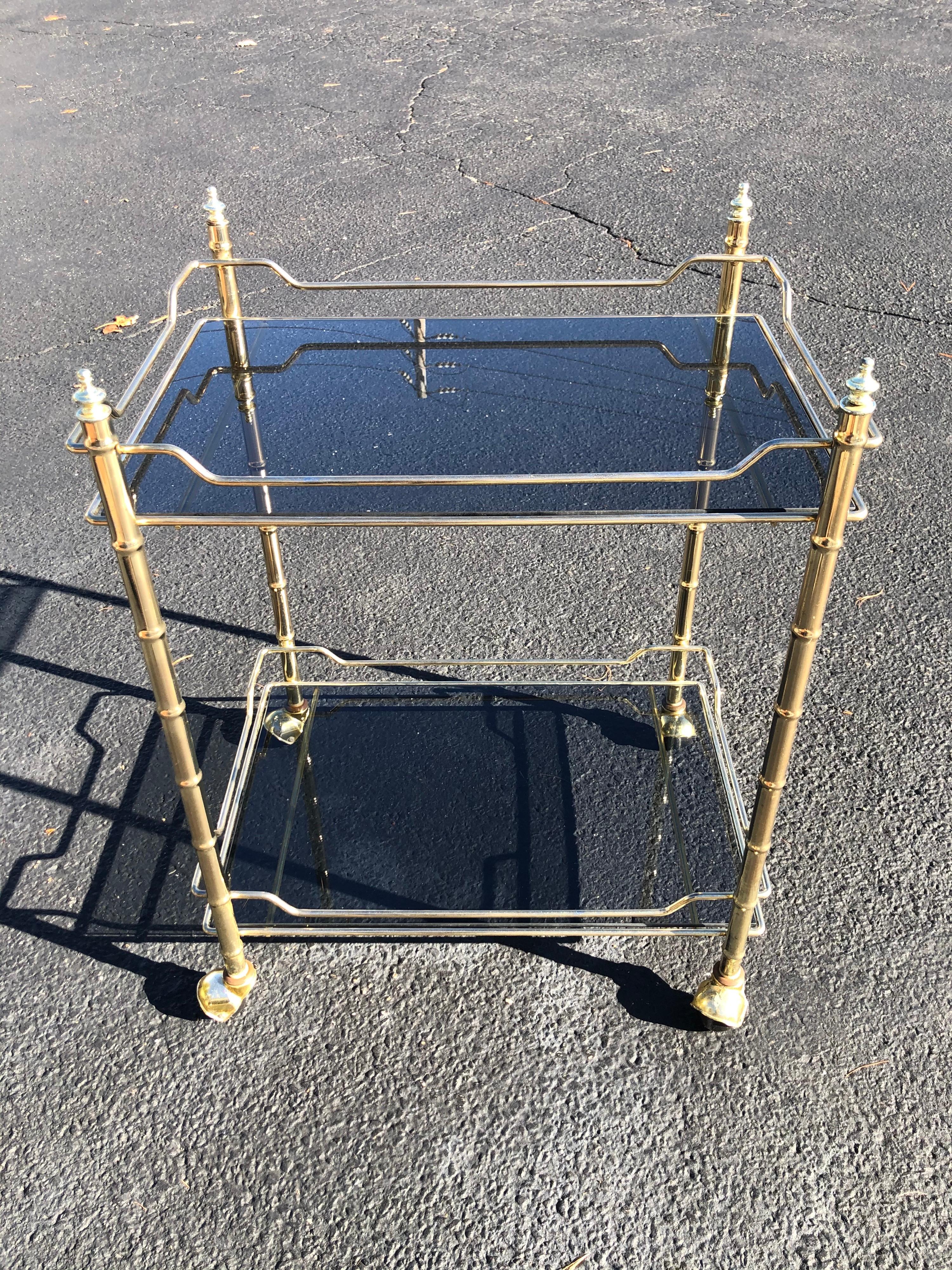 Hollywood Regency smoked glass and brass bar cart. Perfect for entertaining on. Sleek and sexy for that city apartment.