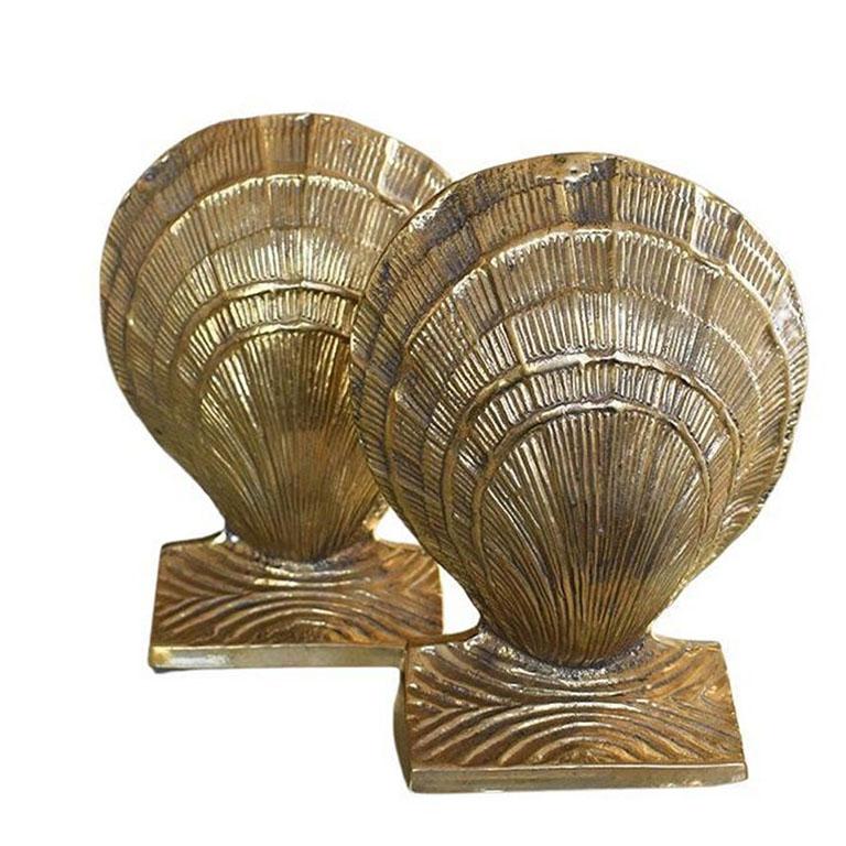 A pair of two solid brass clam shell bookends. This set would be wonderful on a desk, bookshelf or dressing table. 

Measures: 4.75