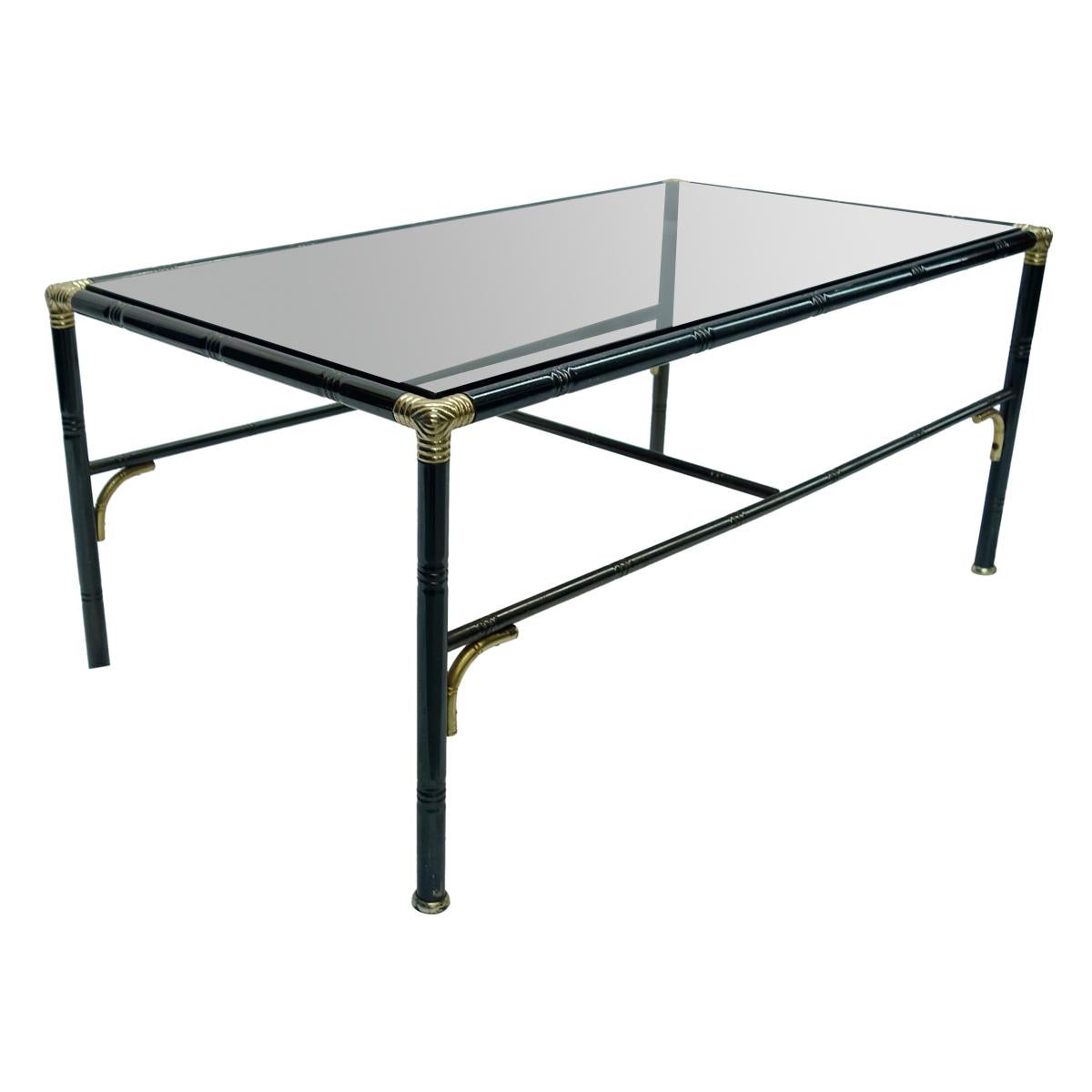 Hollywood Regency black steel rectangular faux bamboo coffee table with brass corners and details. The smoke glass top finishes off the elegance of this beautiful piece.