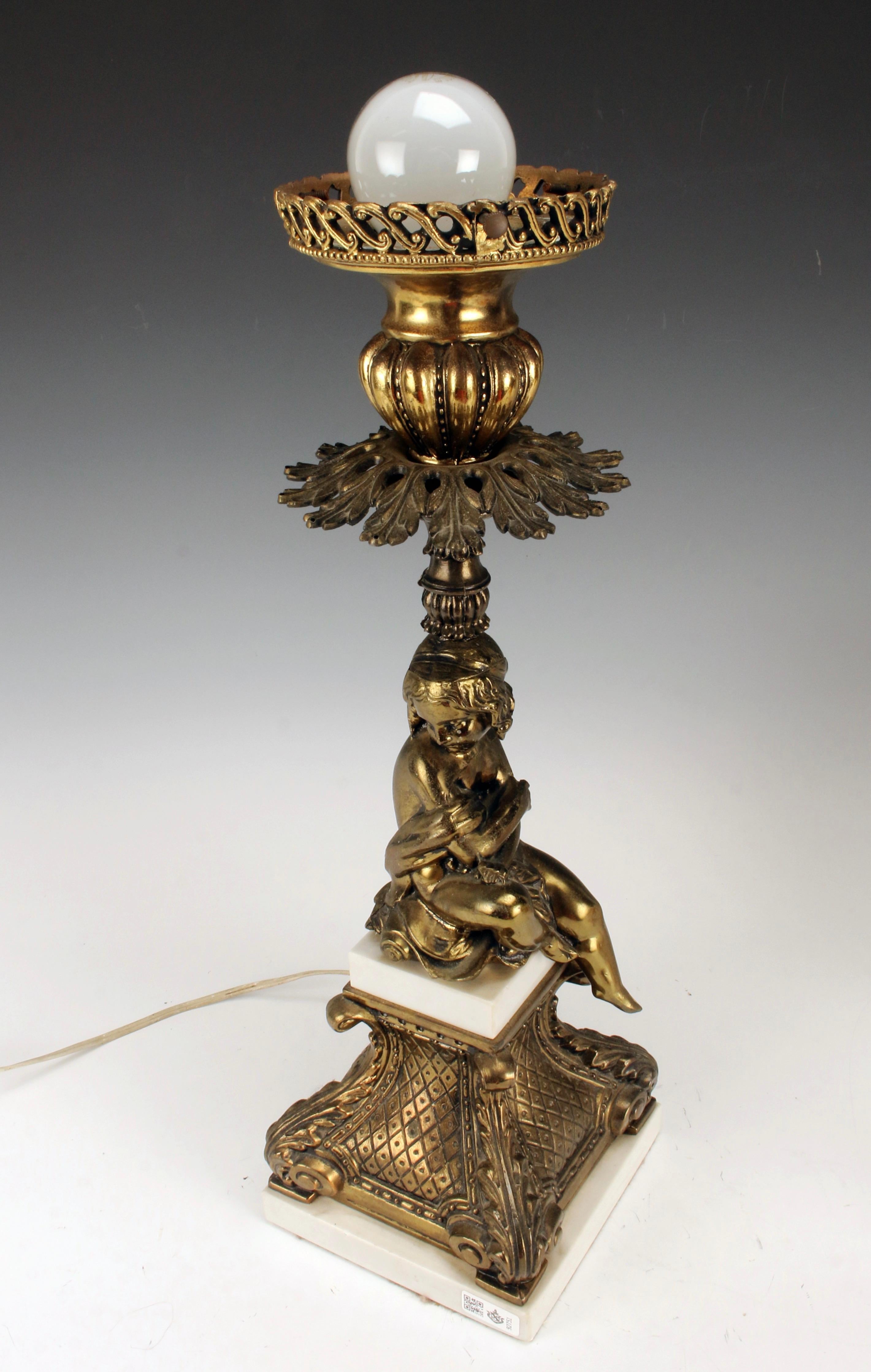 Ornately decorated lamp base with a seated female on a pedestal. Street lamp style frosted glass globe with crackle finish.





