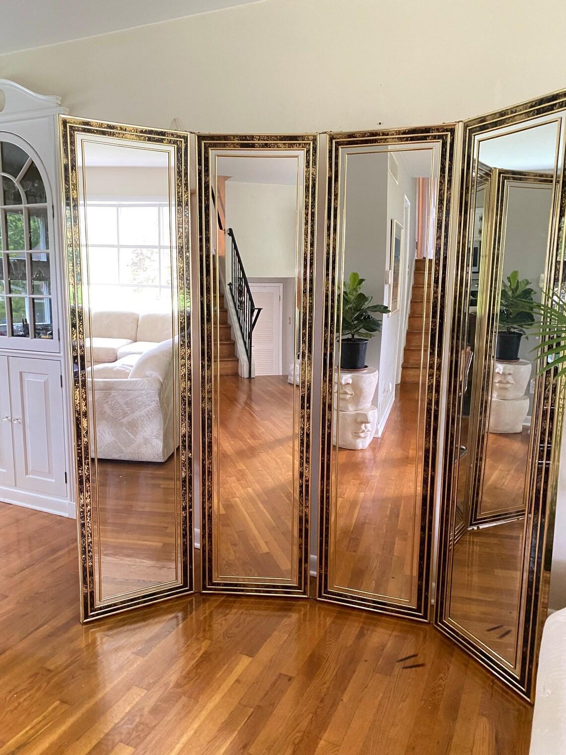 Embrace the timeless elegance of Hollywood Regency with our exquisite adjustable 4-panel floor mirror/room divider. This stunning piece effortlessly combines opulence and functionality, featuring a lavish design that pays homage to the golden age of