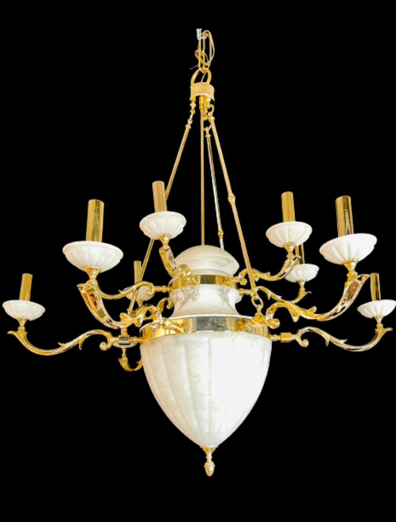 Hollywood Regency style Alabaster chandelier having 12 Lights. This large and impressive chandelier has 12 recently wired lighted arms with alabaster boboches flowing from the brass scrolled arms all having a alabaster dome column form center