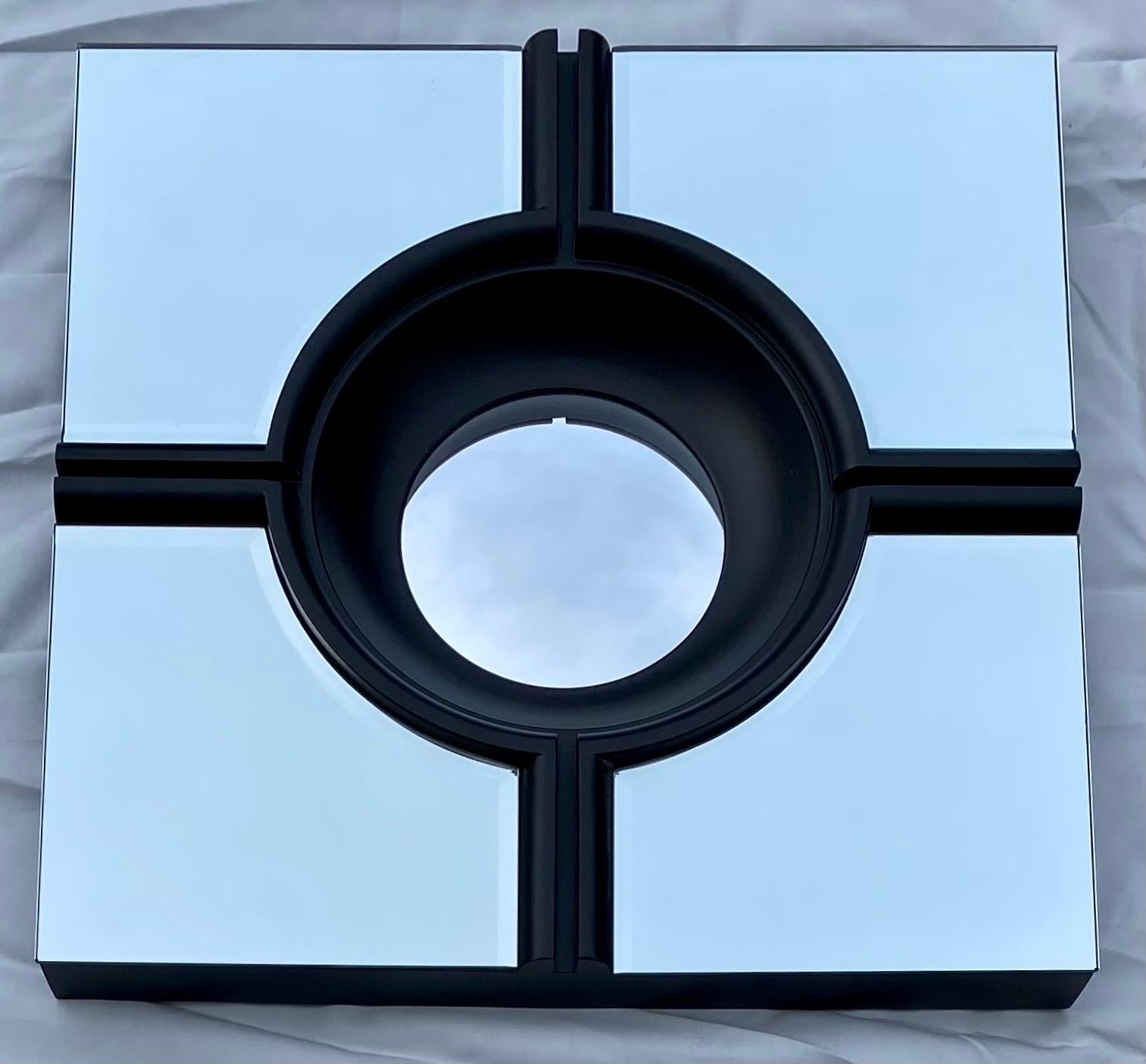 Hollywood Regency style set of four square mirror panels with beveled edges and round bullseye centers. This architectural set of matte black mirrors can be hung in a variety of configurations to fit your space. Each mirror attaches to the wall with