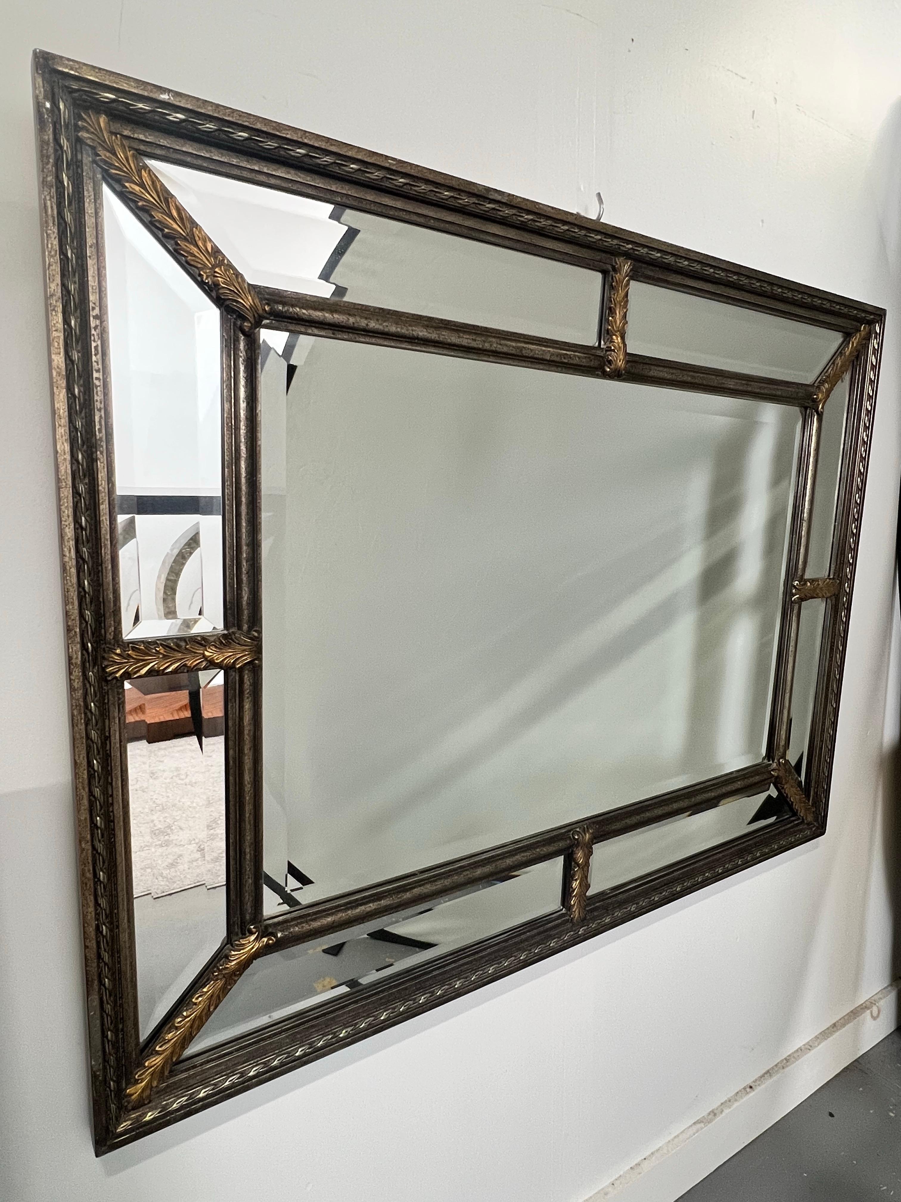 Hollywood Regency Style Beveled Multi-Panel Mirror with Rope & Gilt Leaf Design
A striking large-scale wall mirror in the Hollywood Regency style, featuring a sophisticated segmented design with multiple beveled mirror panels. The frame is adorned